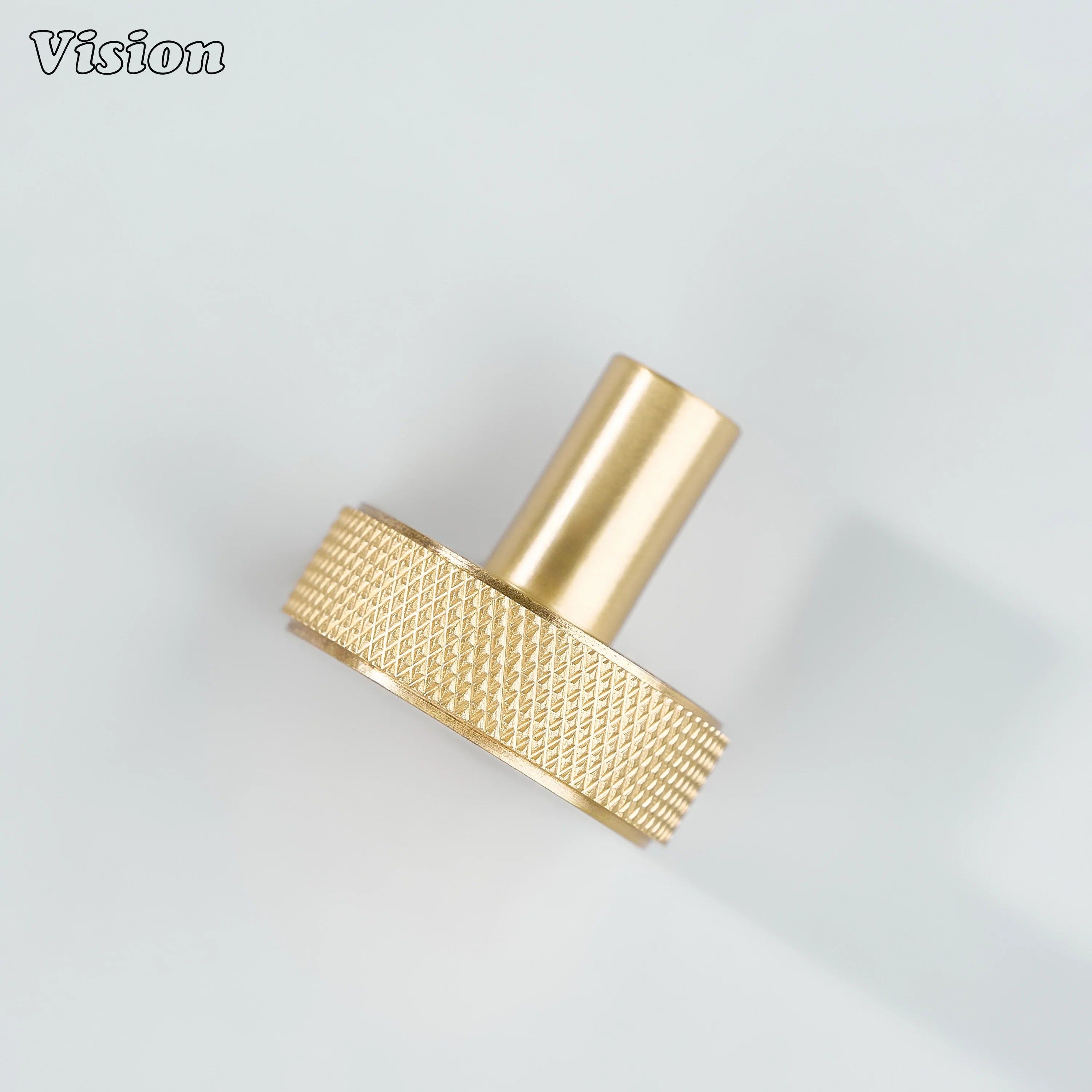 Gold round cabinet knob with precision knurling and clean cylindrical stem for drawers