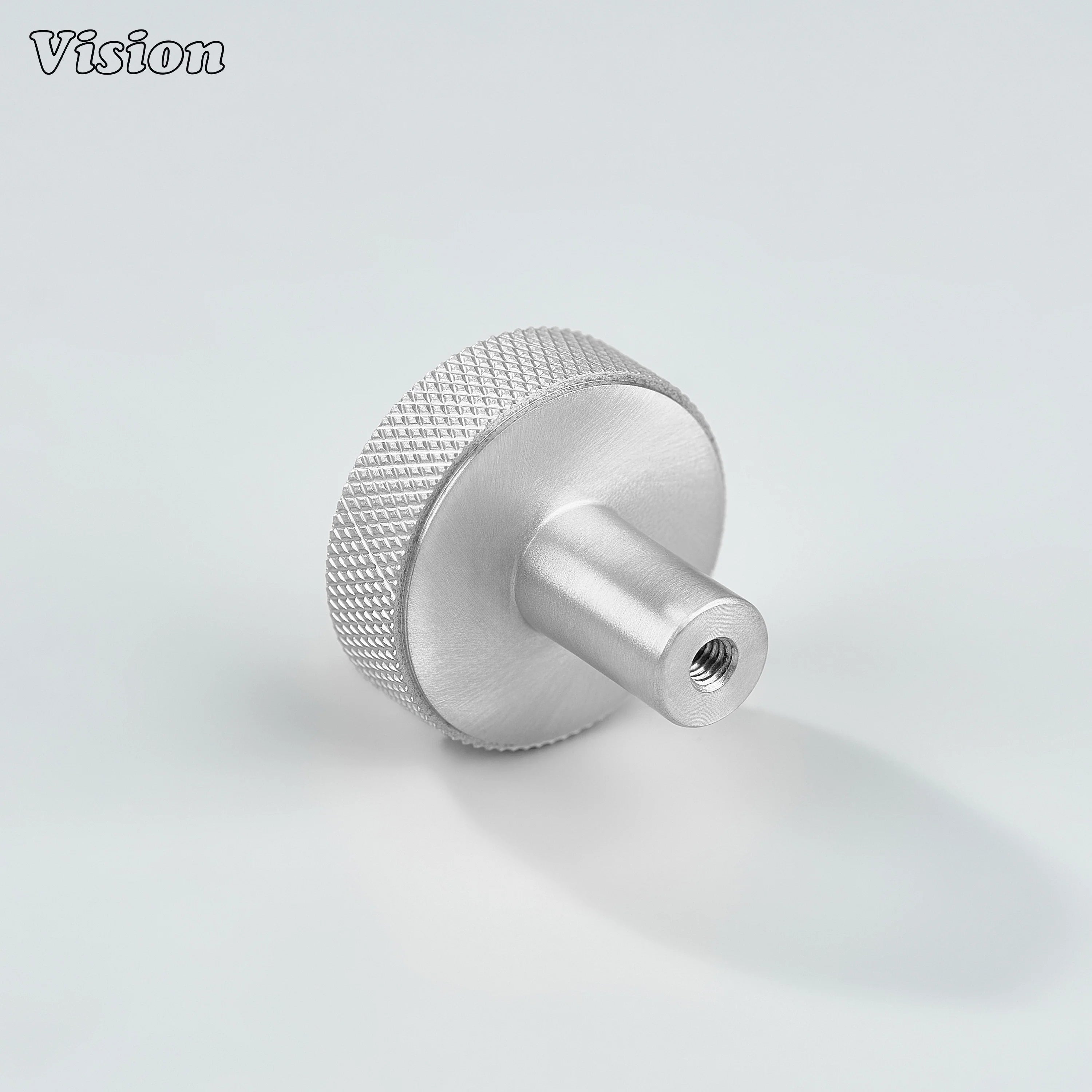 Silver cabinet knob with textured knurled sides and flat round top