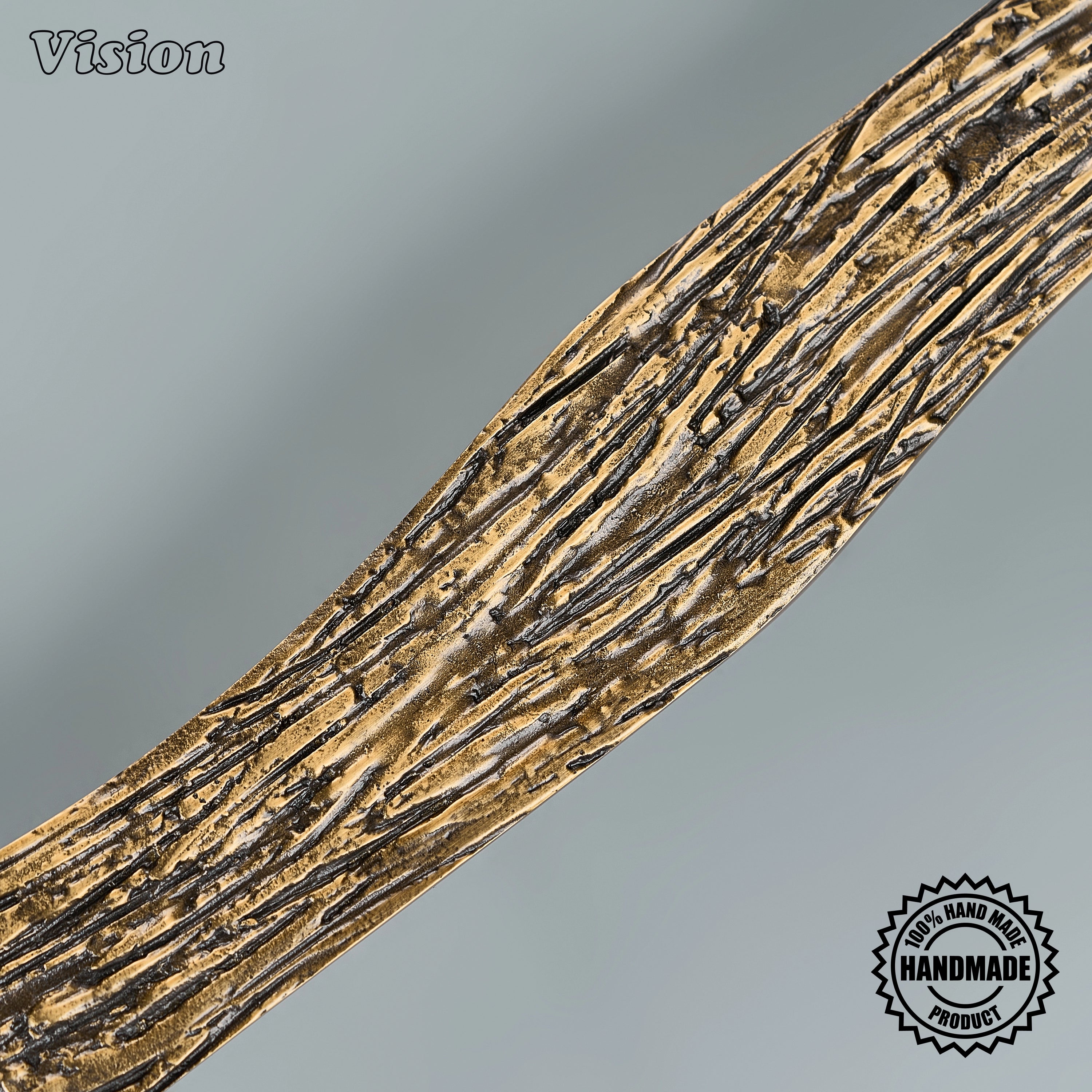 Textured black sculpted pull handle with deep woodgrain ridges on custom paneled appliances