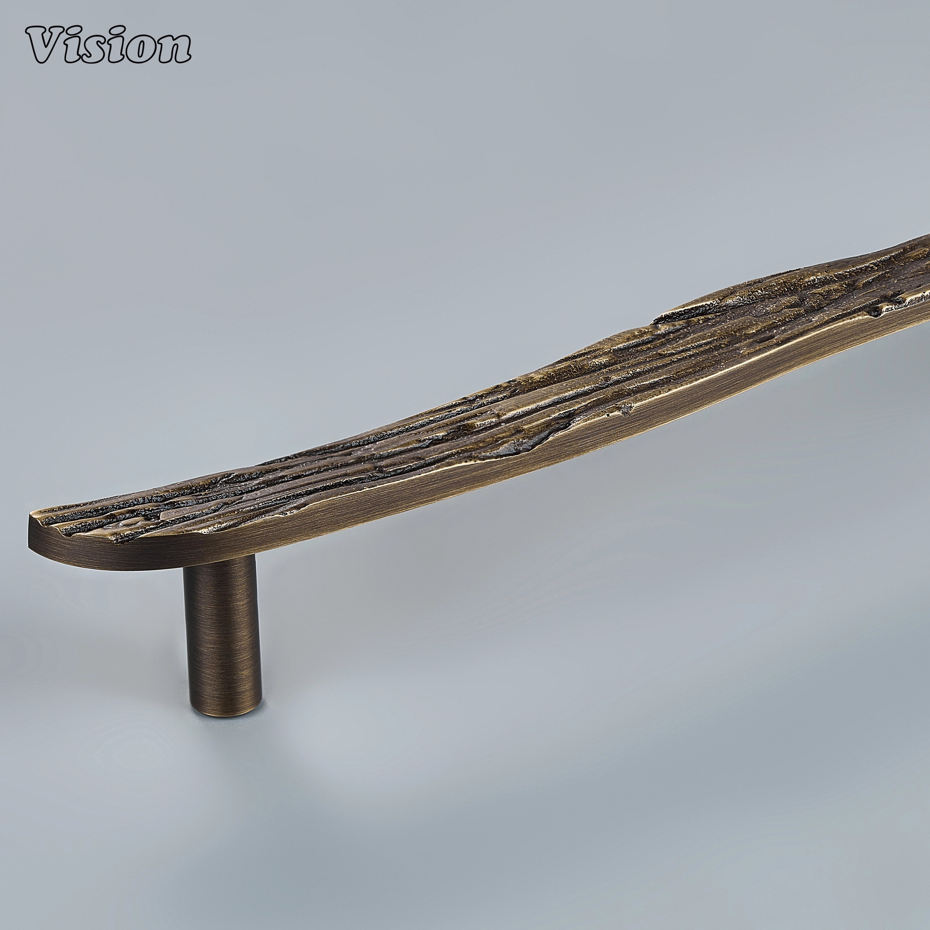 Antique Bronze handcrafted cabinet pull with deeply grooved bark texture on custom kitchen cabinets
