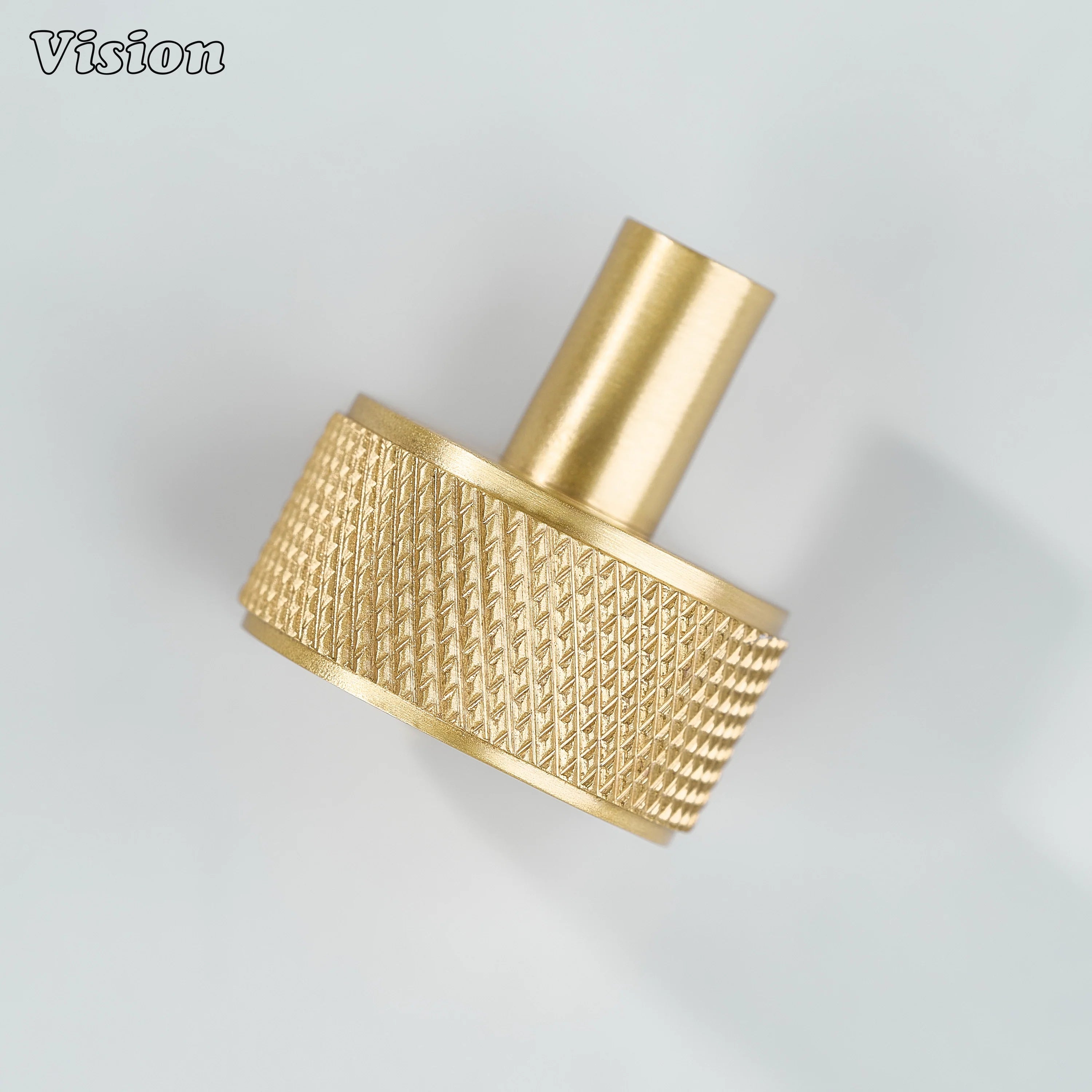 Gold cabinet knob with textured round top and sturdy cylinder leg for cabinet doors
