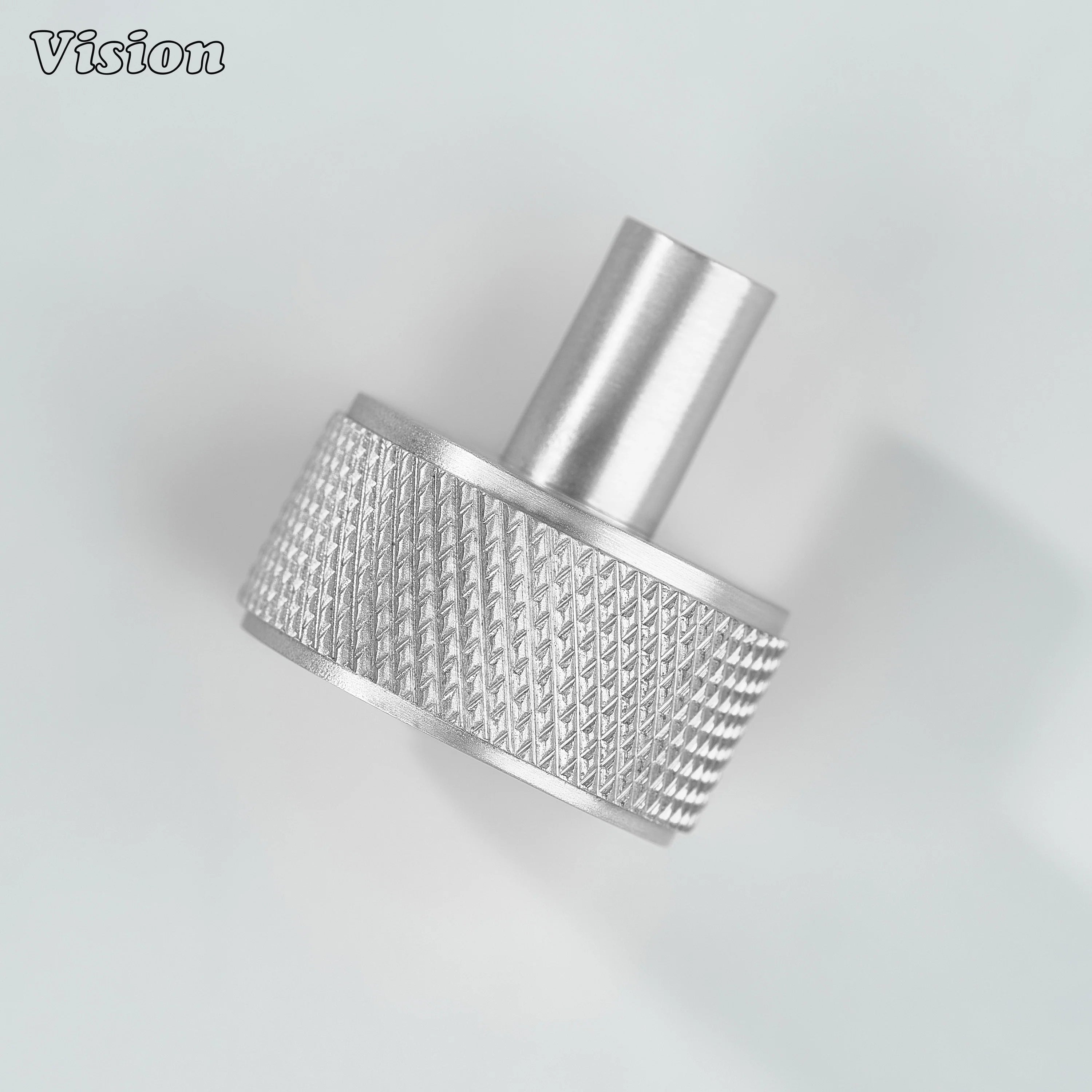 Silver round cabinet knob with detailed textured profile for cabinet doors