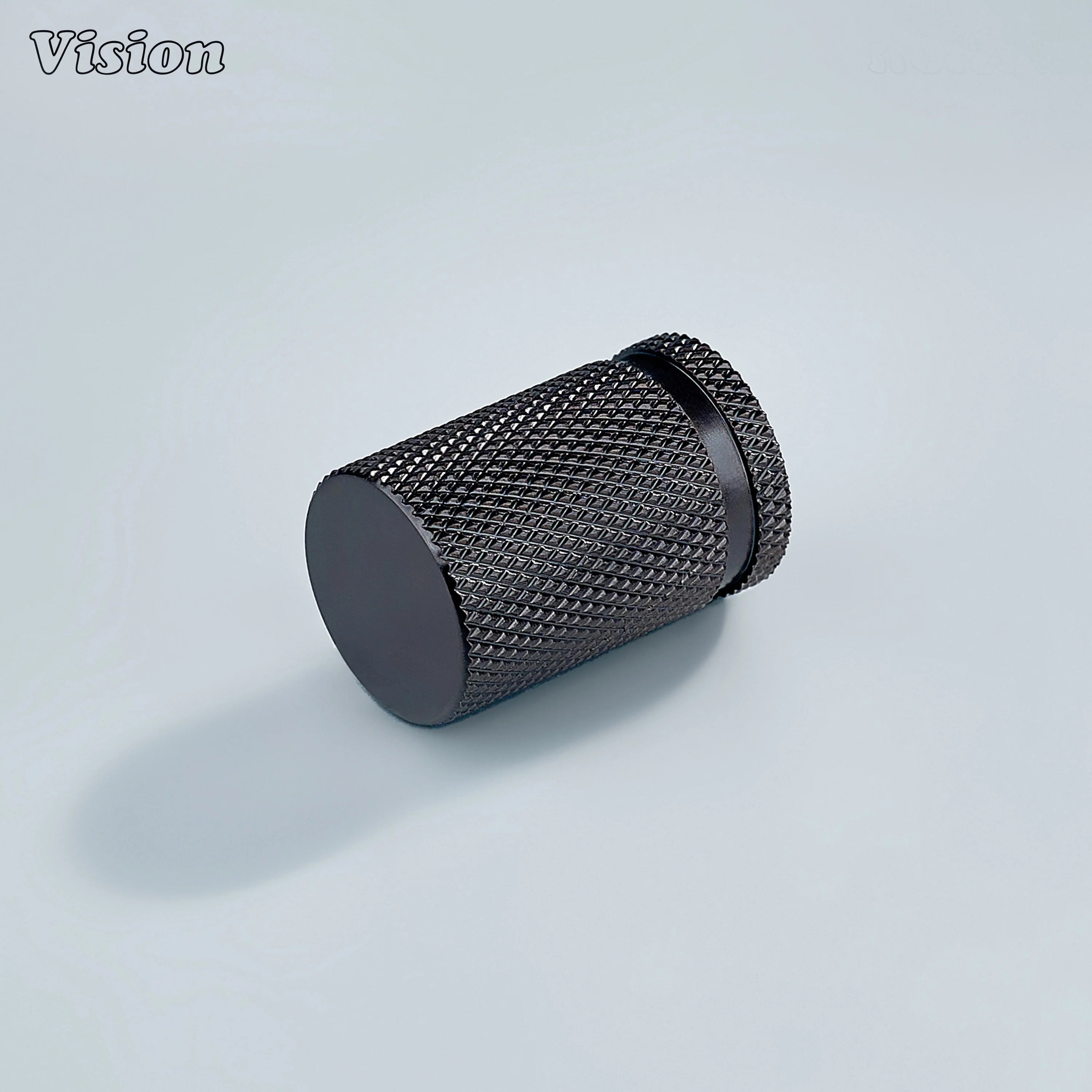 Modern brass knurled cylinder cabinet knob in bronze finish used for furniture drawers.