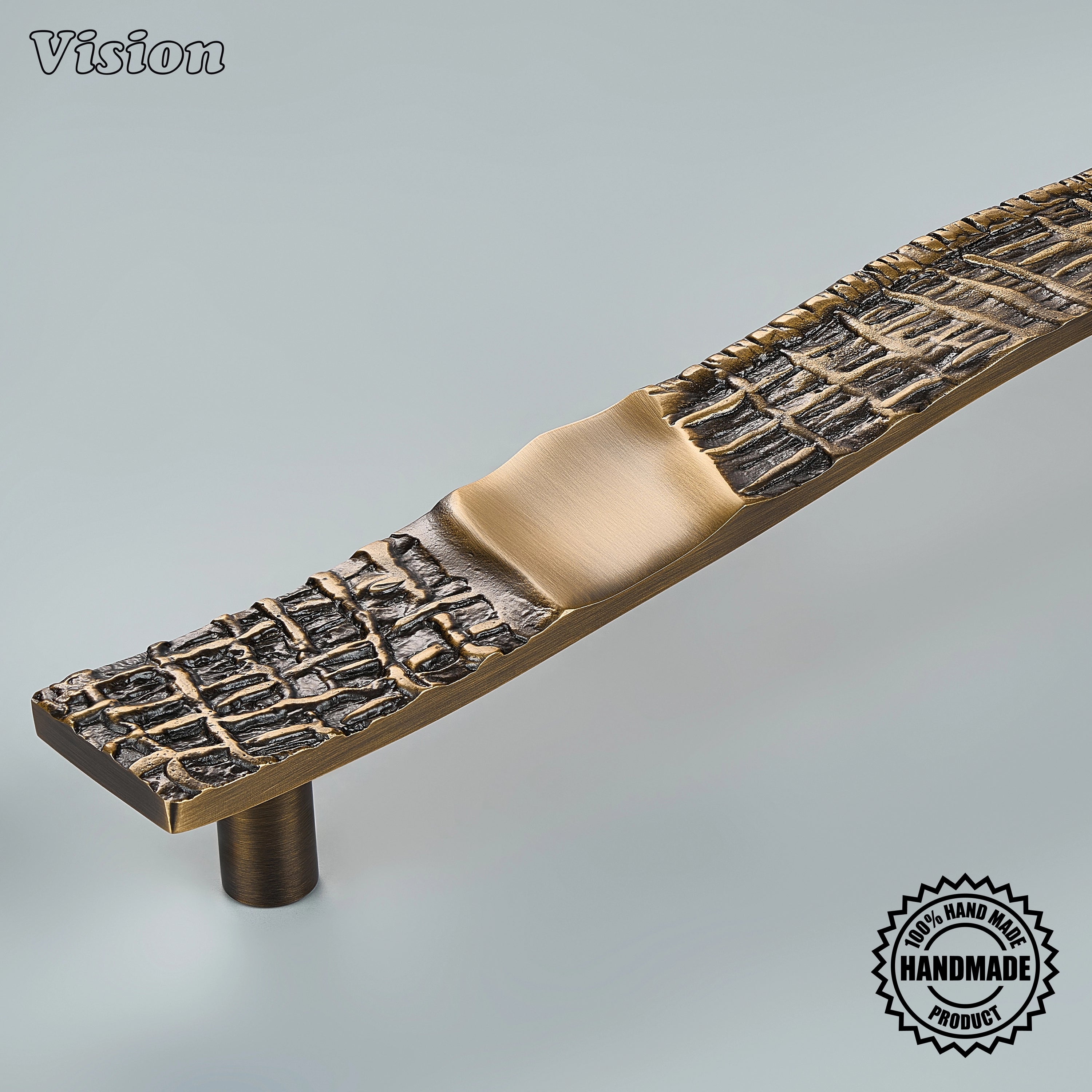 Sculpted antique bronze appliance handle with crisscross grid pattern on panel-ready refrigerators