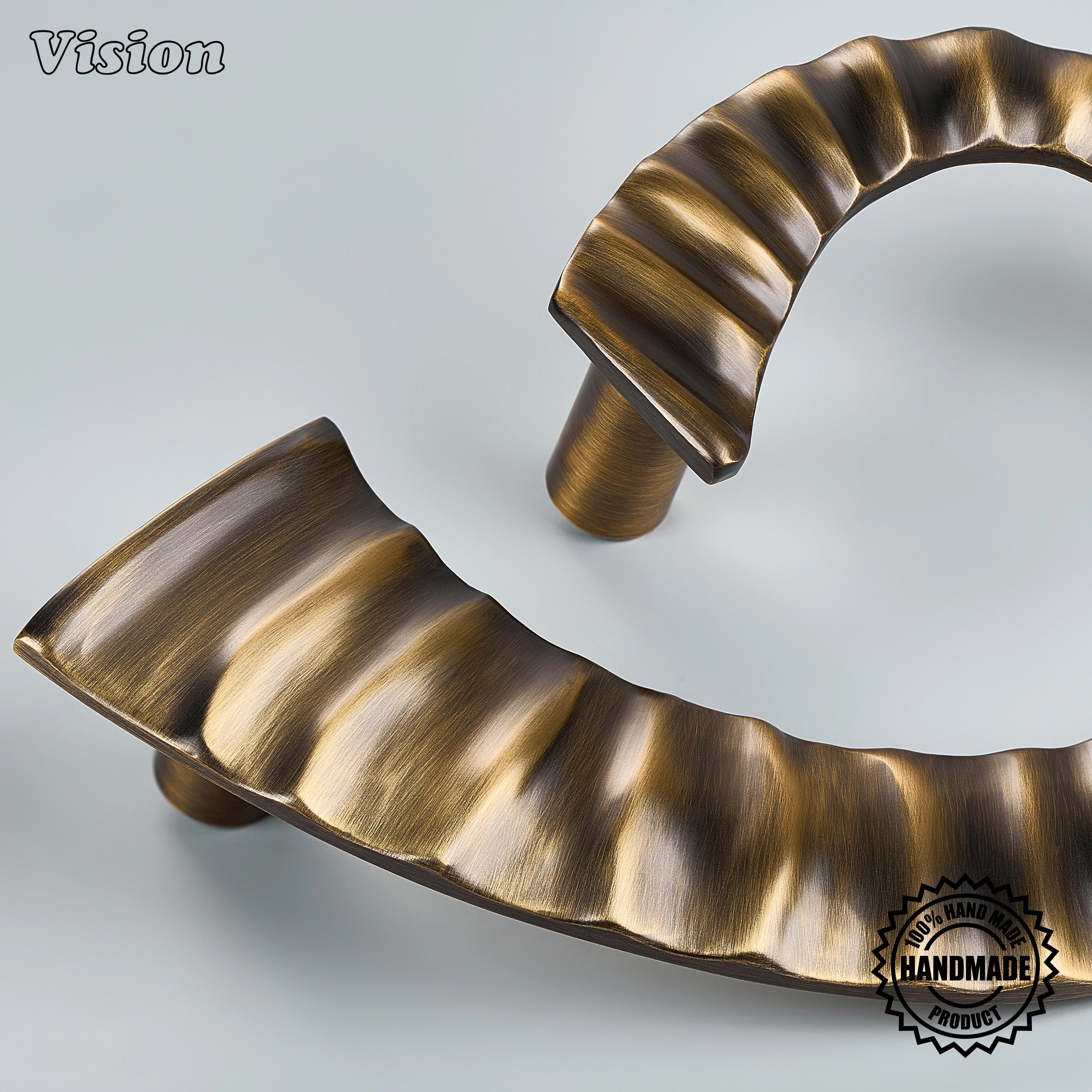 Calyx Antique Bronze handcrafted door handle with flowing fluted curves and cylindrical end details for luxury interior doors.