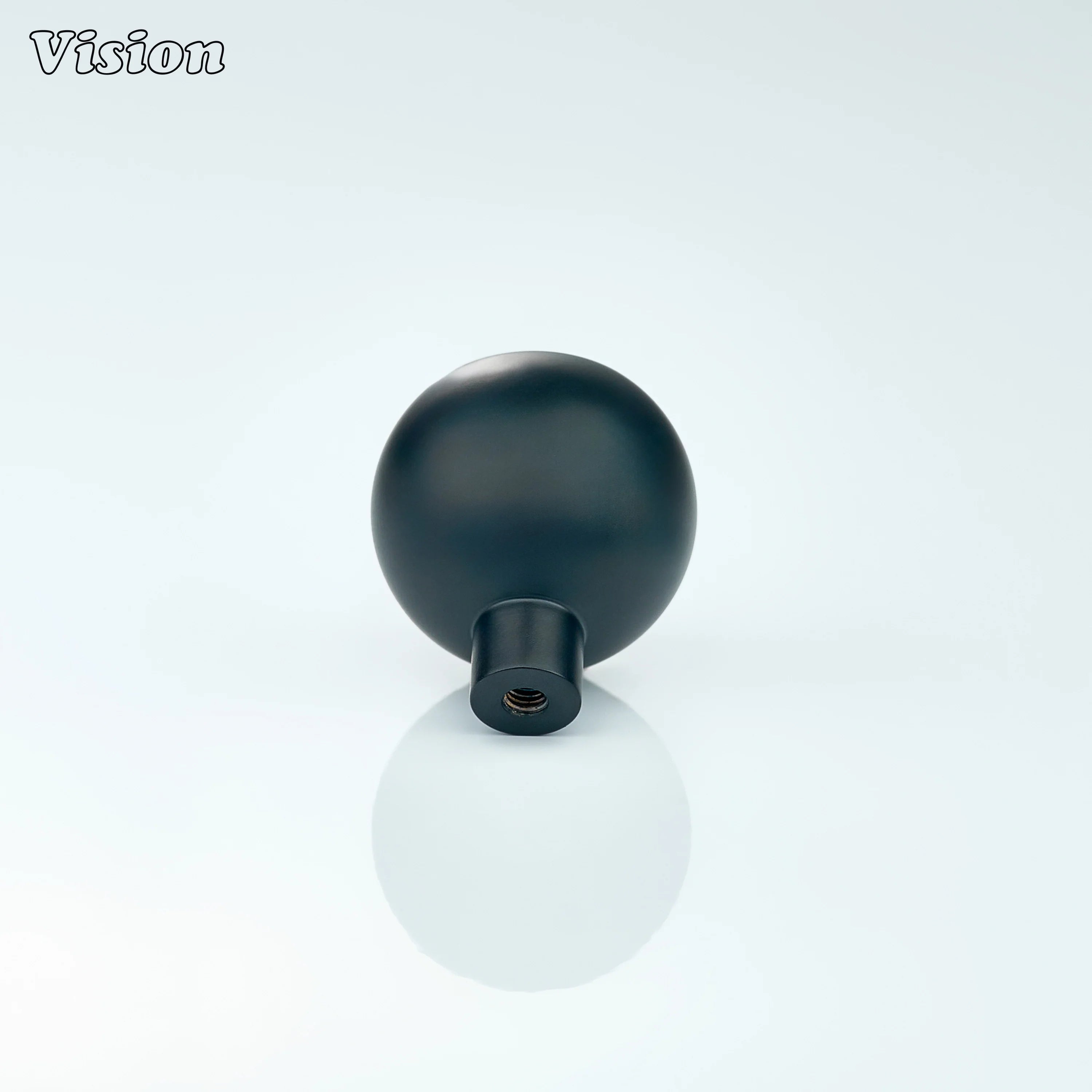 Black round cabinet knob with fine linear texture, designed for kitchen drawers
