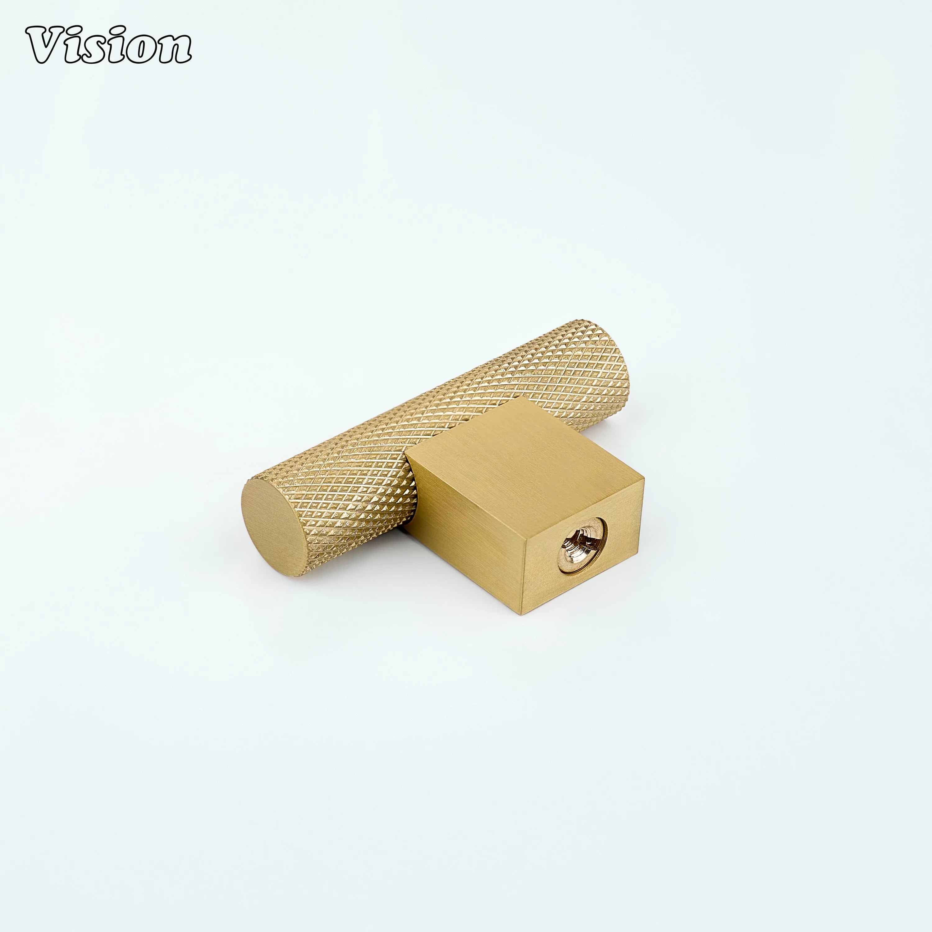 Gold brass t-knob with knurled cylindrical bar mounted on kitchen drawers