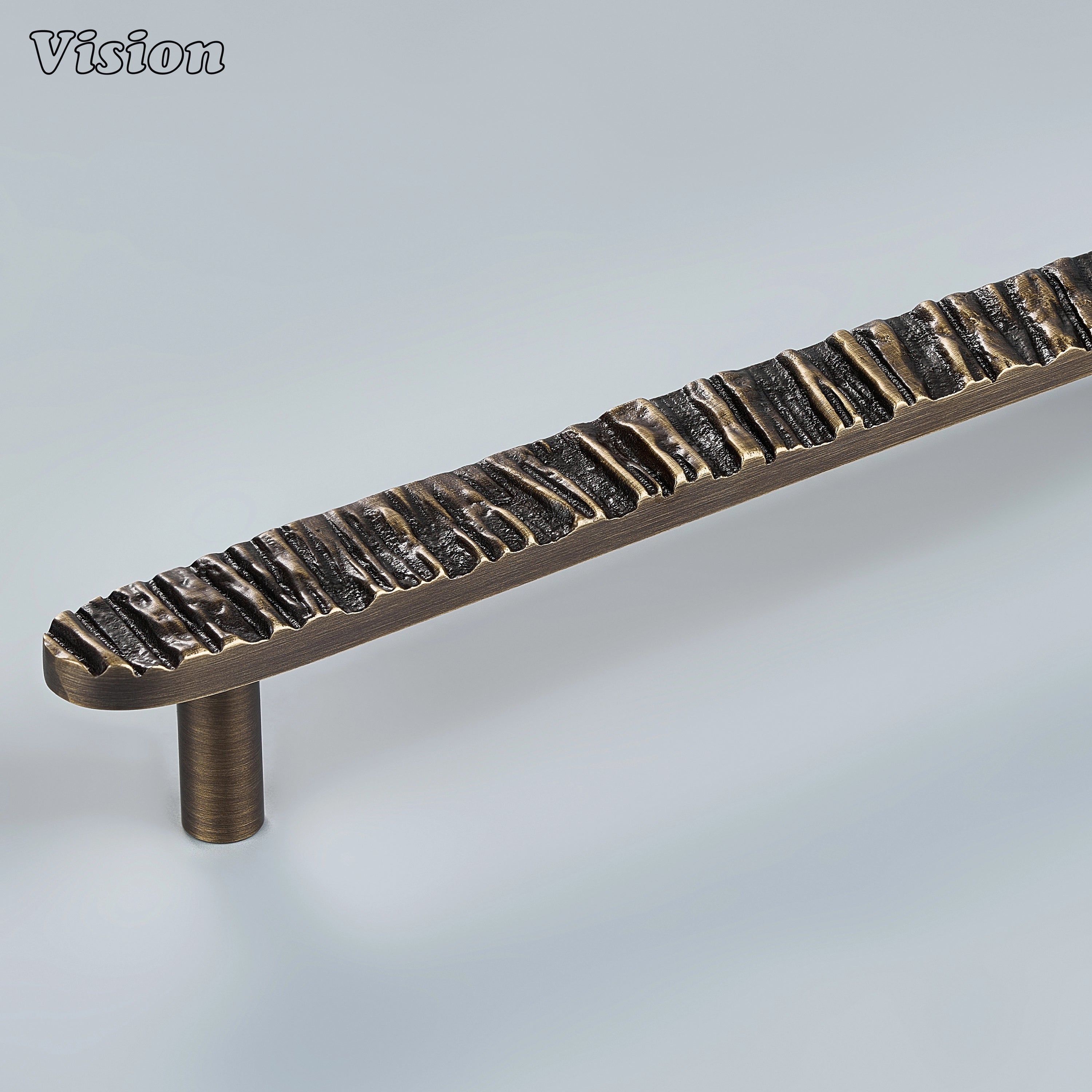 Antique Bronze handcrafted cabinet pull with deep bark texture on modern kitchen cabinets