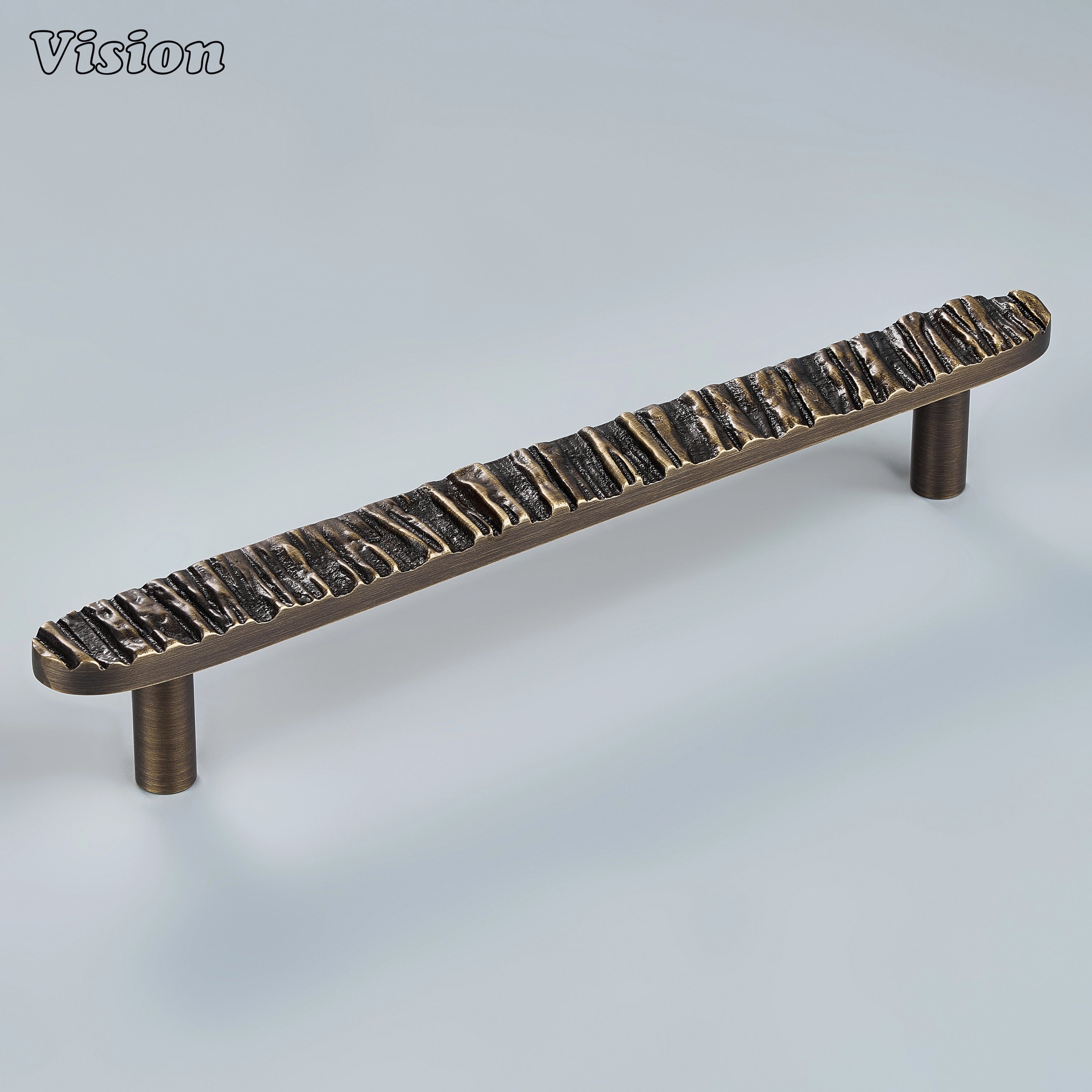 Sculpted antique bronze cabinet handle with organic bark-inspired ridges on statement drawers
