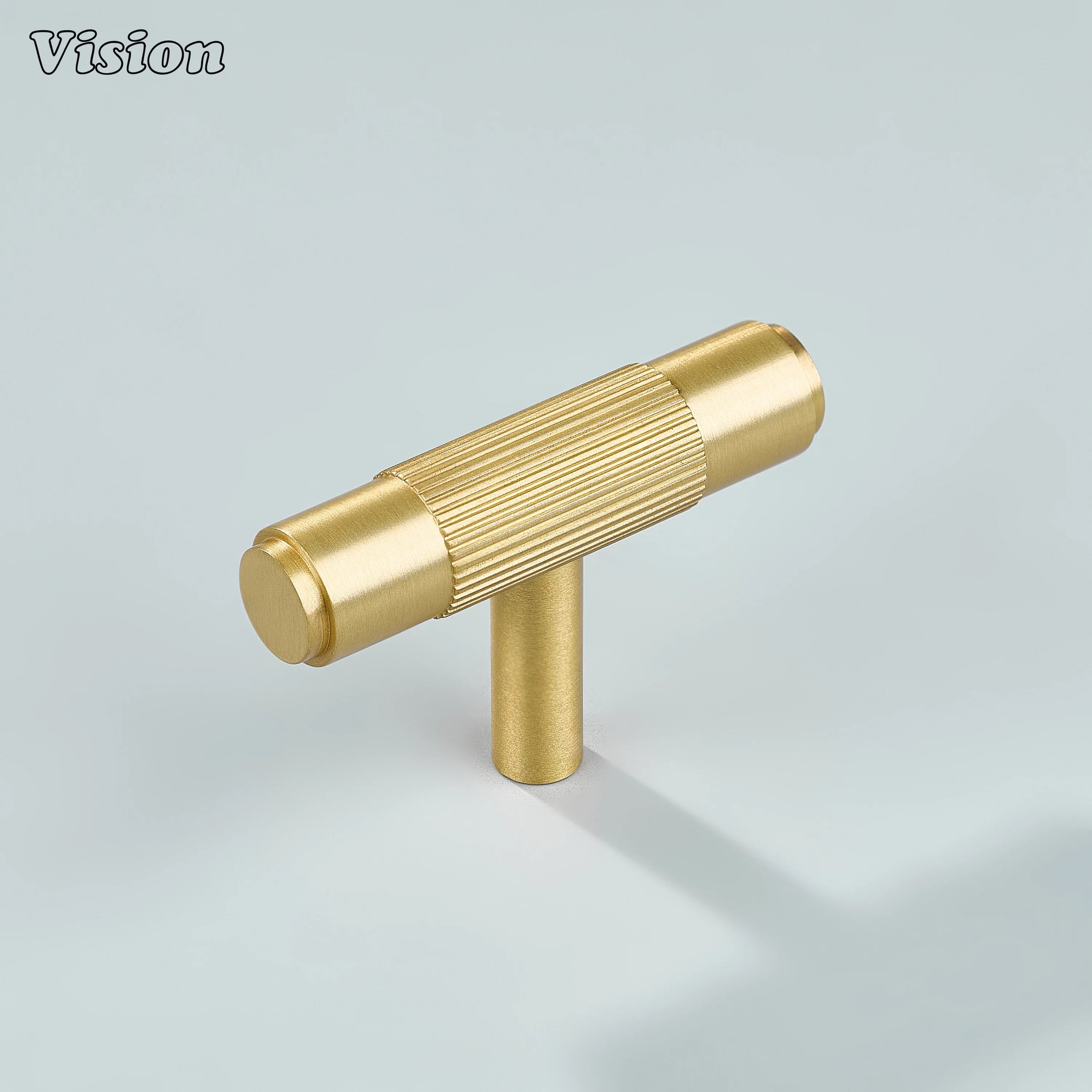 Gold brass linear knurled T-knob for modern kitchen cabinets.