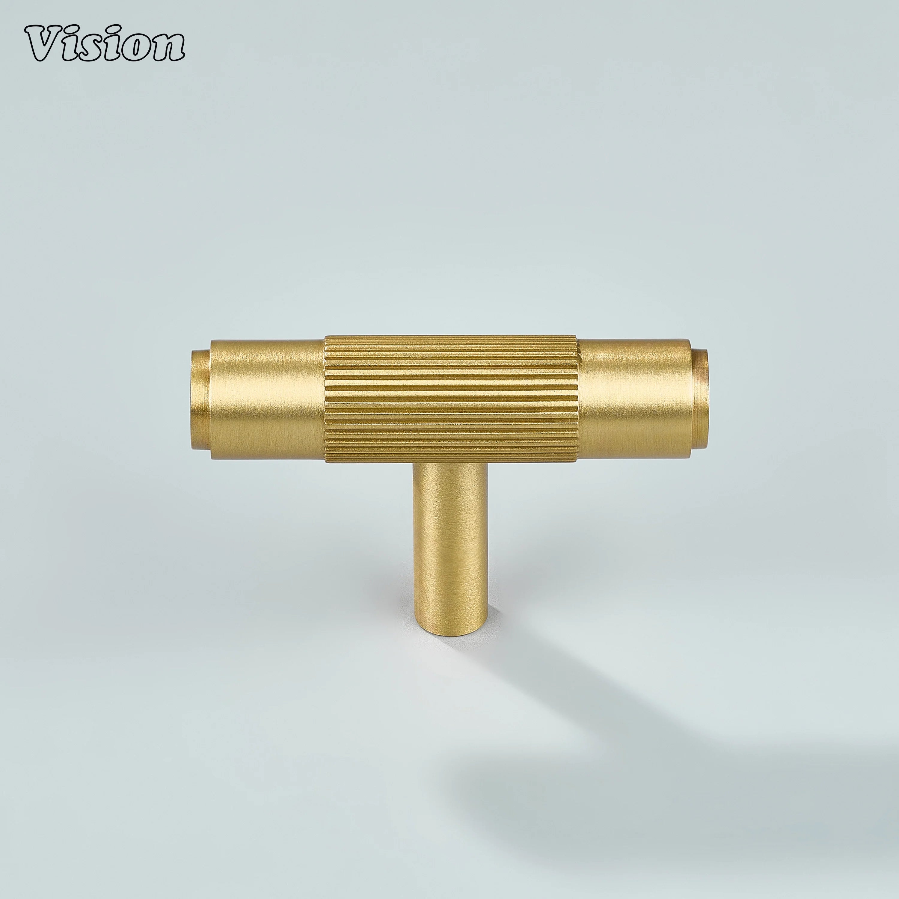 Ignite gold T-knob with fine linear texture for wardrobes.