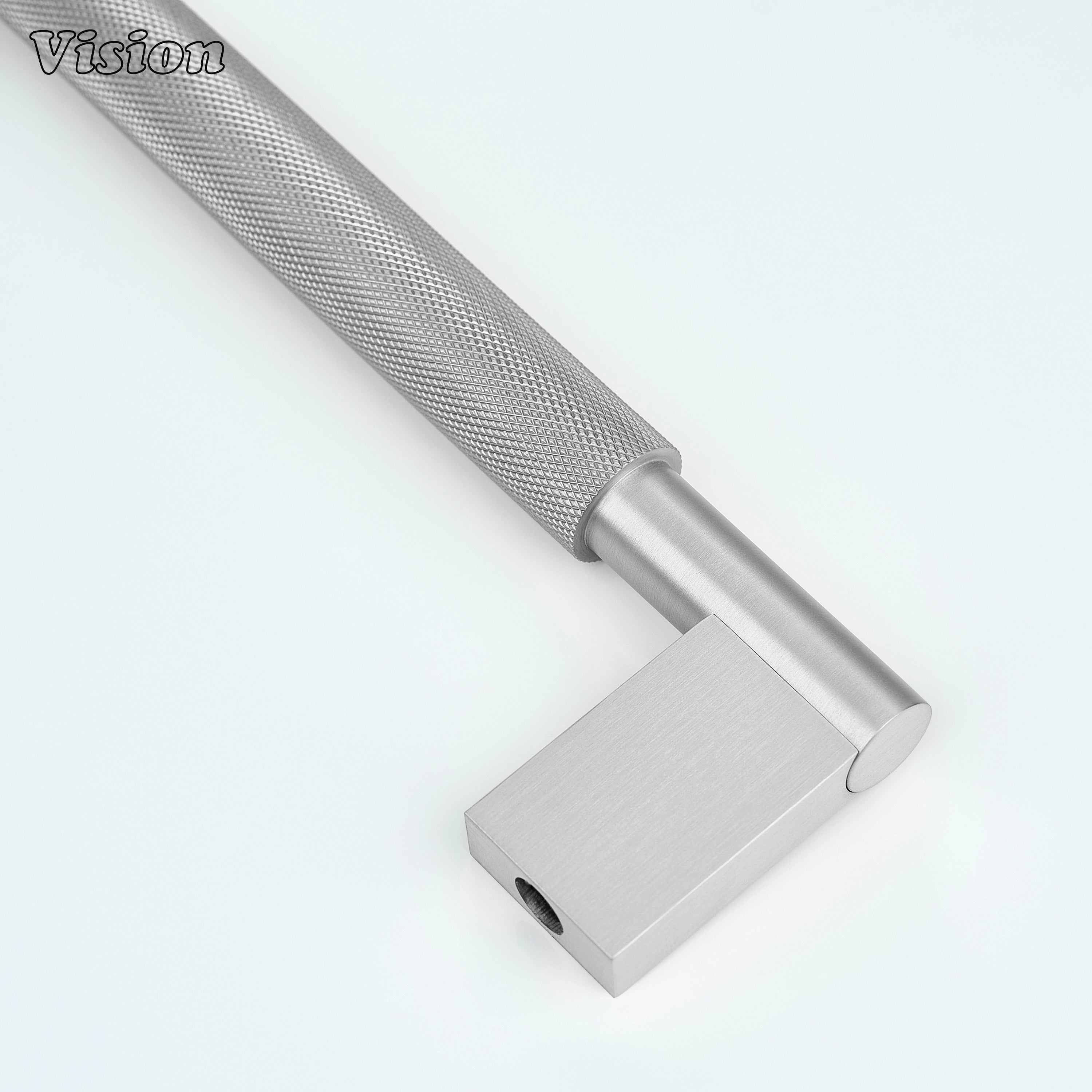 Silver knurled brass appliance pull for integrated freezer drawers.