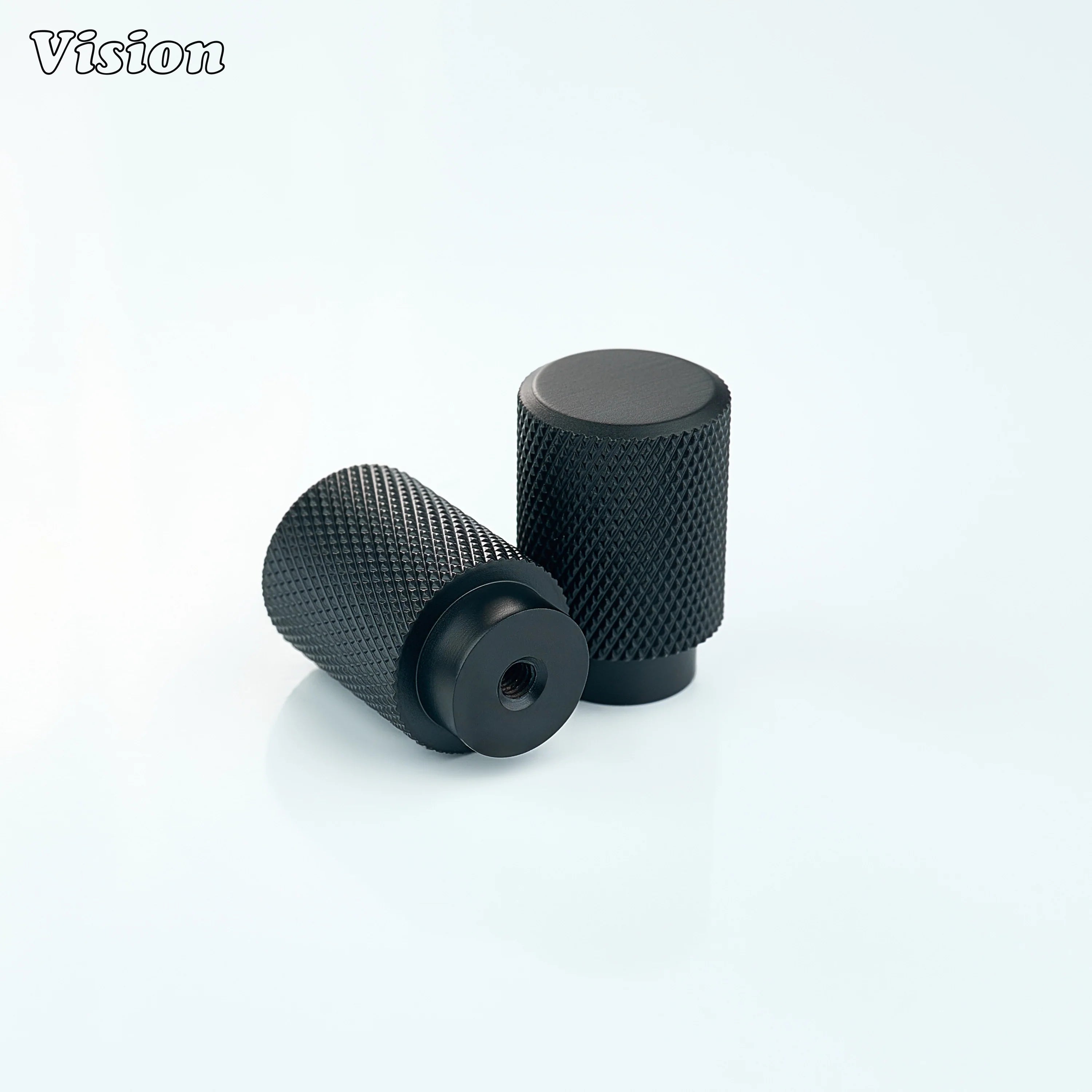Black cabinet knob with knurled cylinder grip for modern kitchens