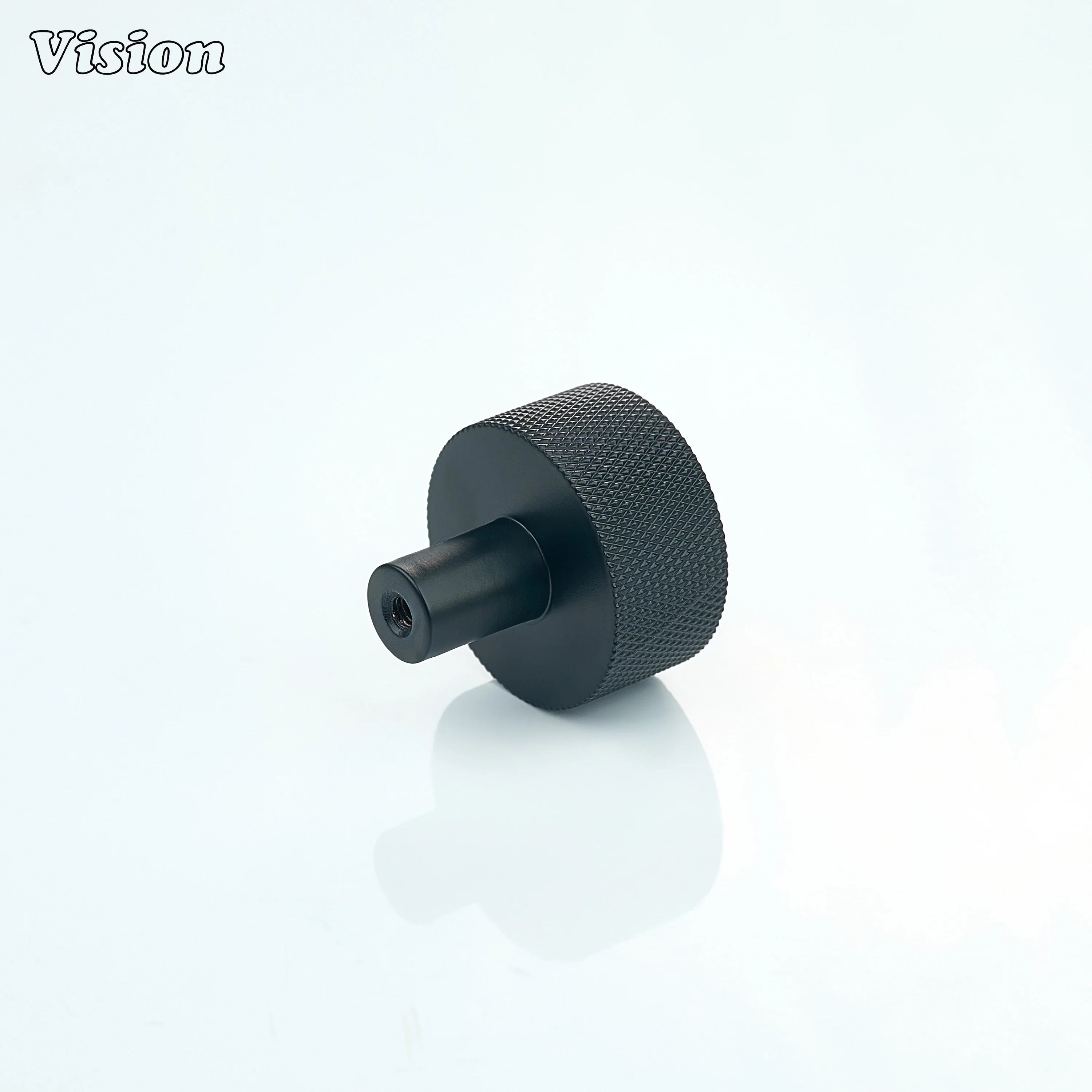 Black round cabinet knob with textured surface for drawer fronts