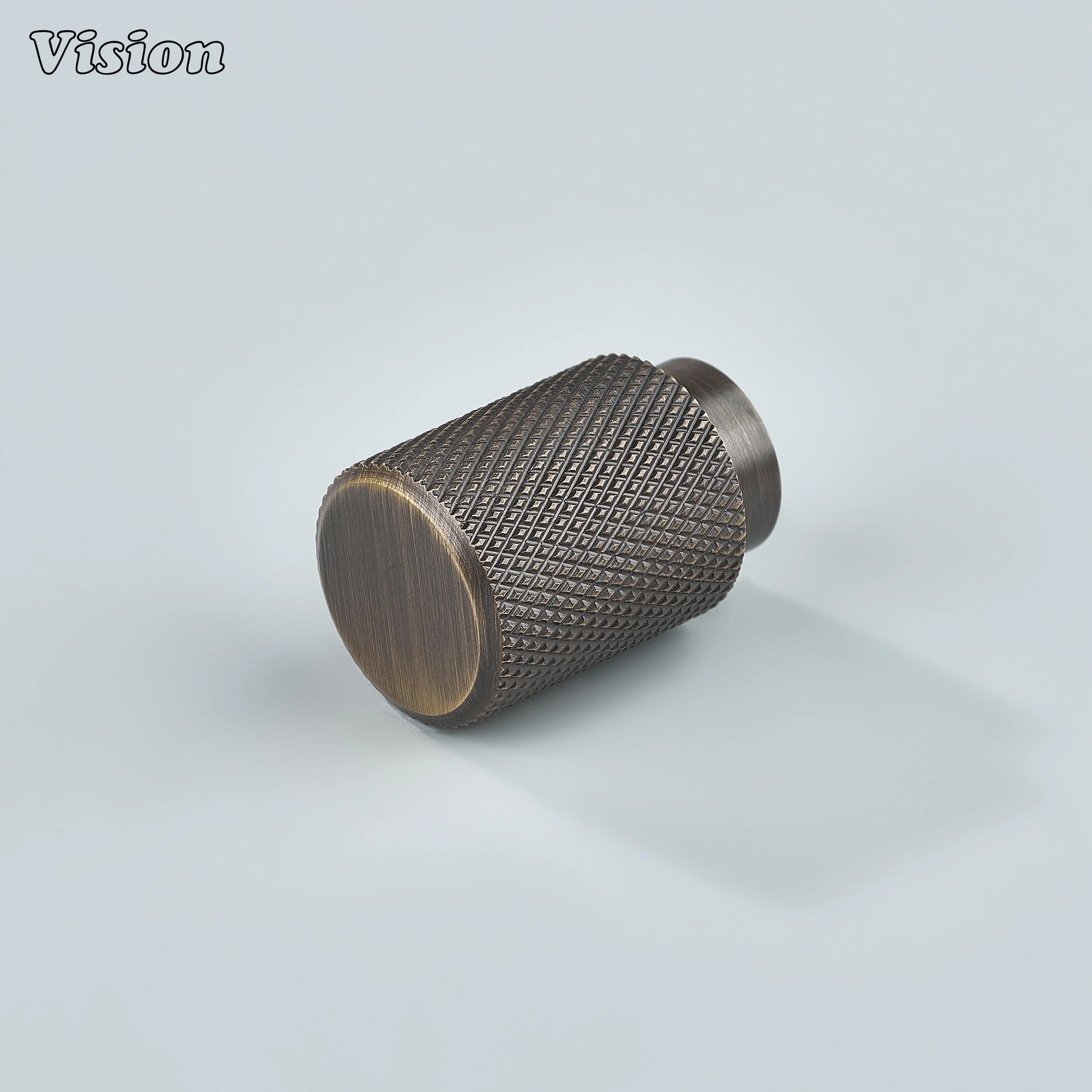 Modern antique bronze knurled cylinder knob used for kitchen cabinets.