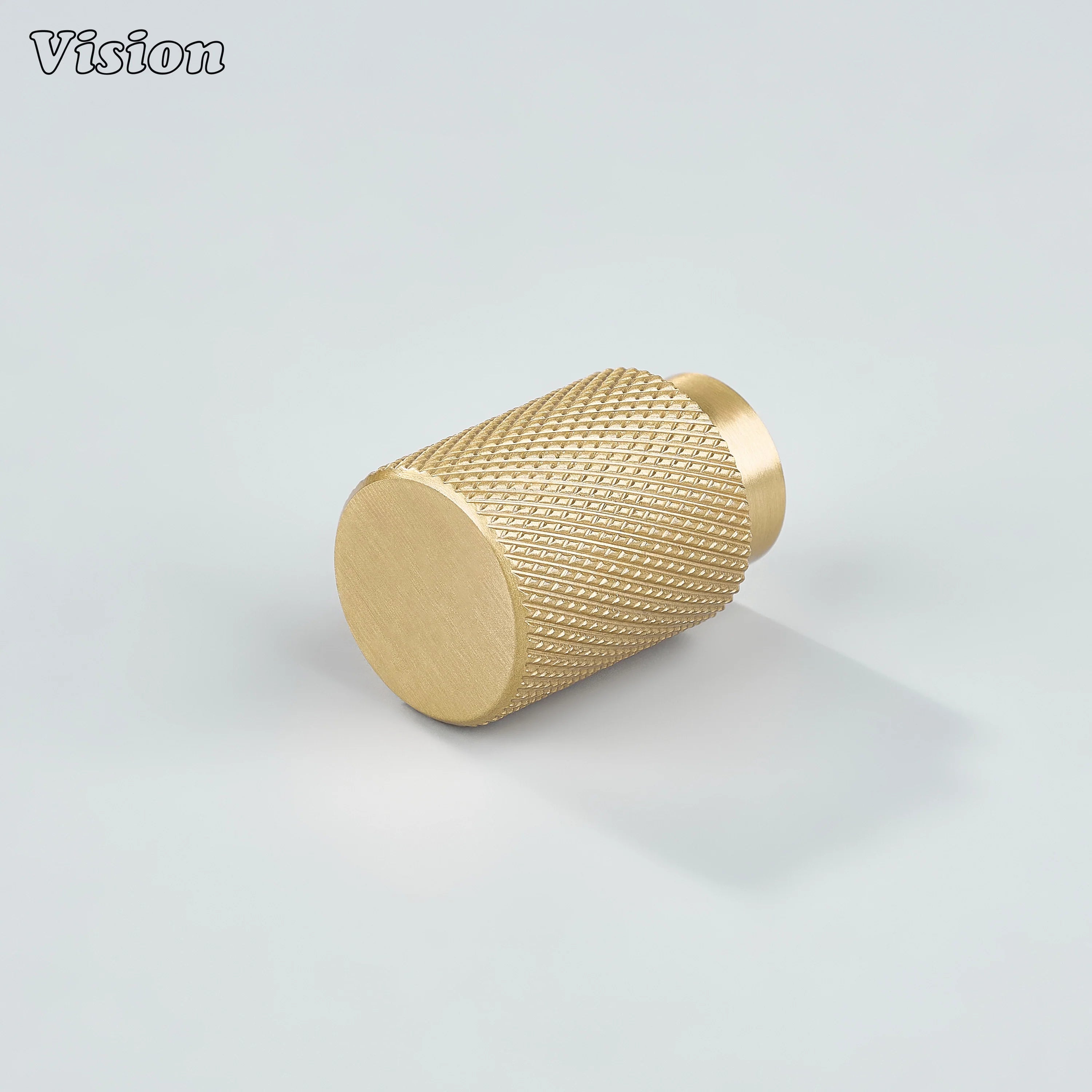 Modern gold knurled cylinder knob used for kitchen cabinets.