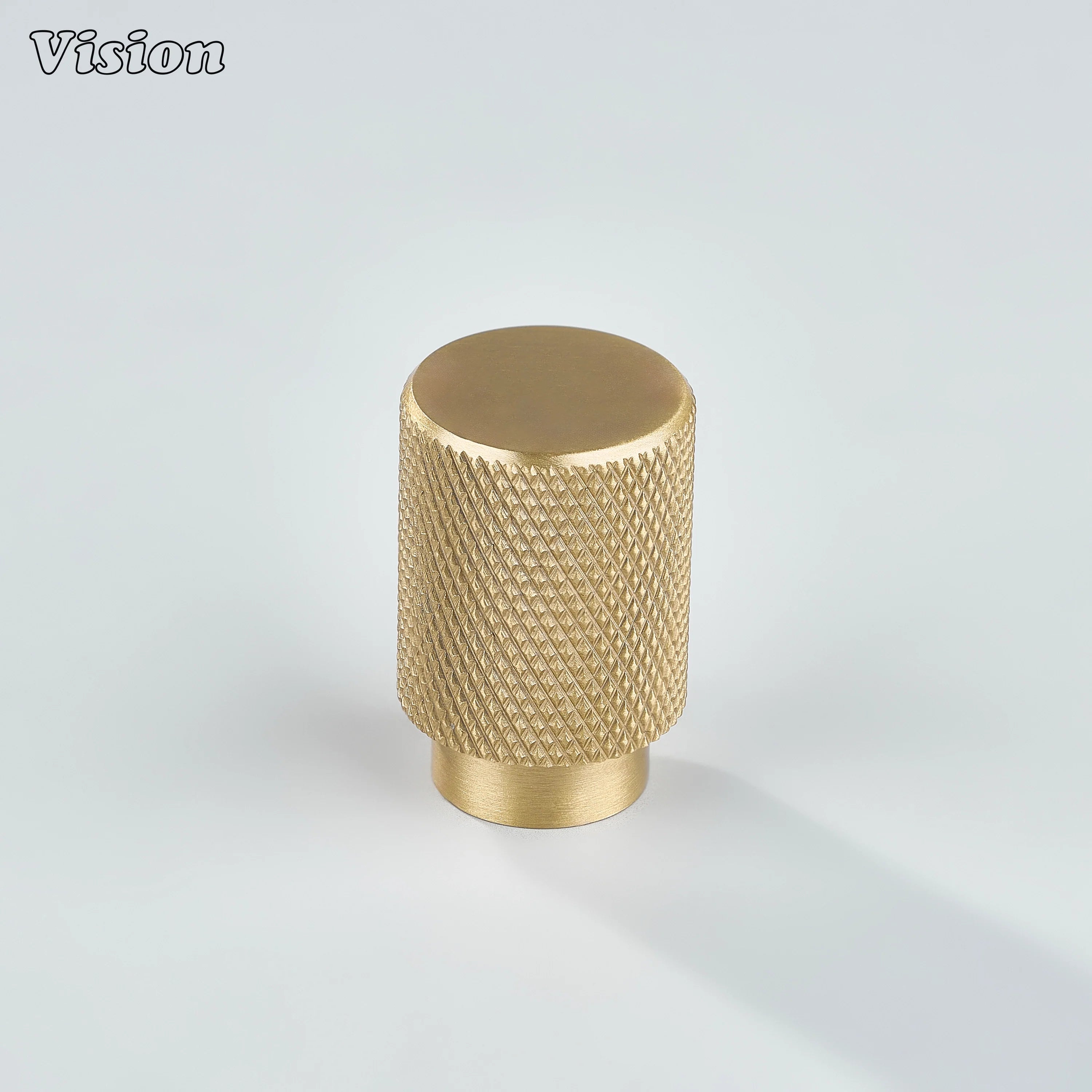 Modern gold knurled cylinder knob used for cupboards.