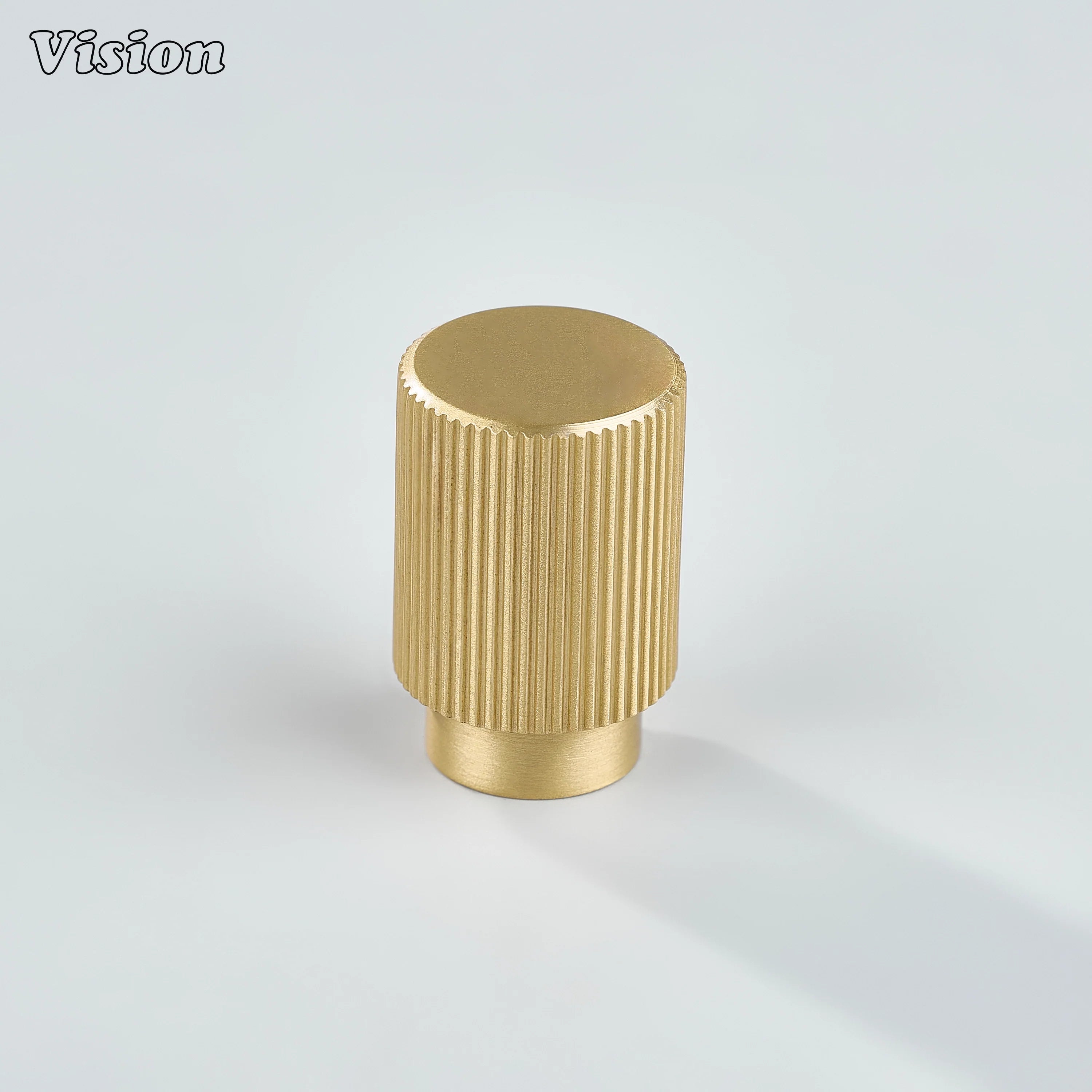 Modern gold cabinet knob with linear knurled detailing for furniture units