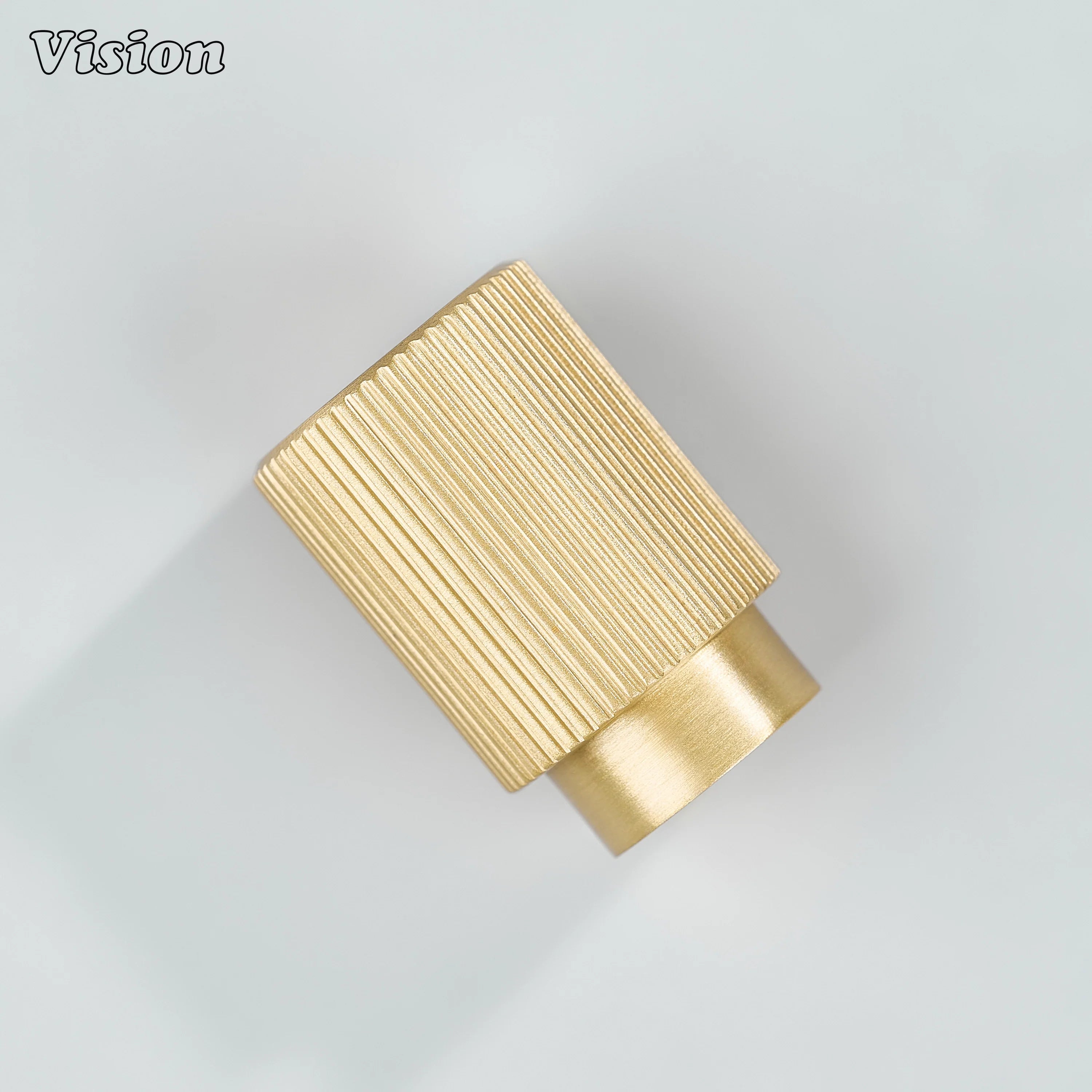 Gold cylinder cabinet knob with fine knurled texture for contemporary furniture