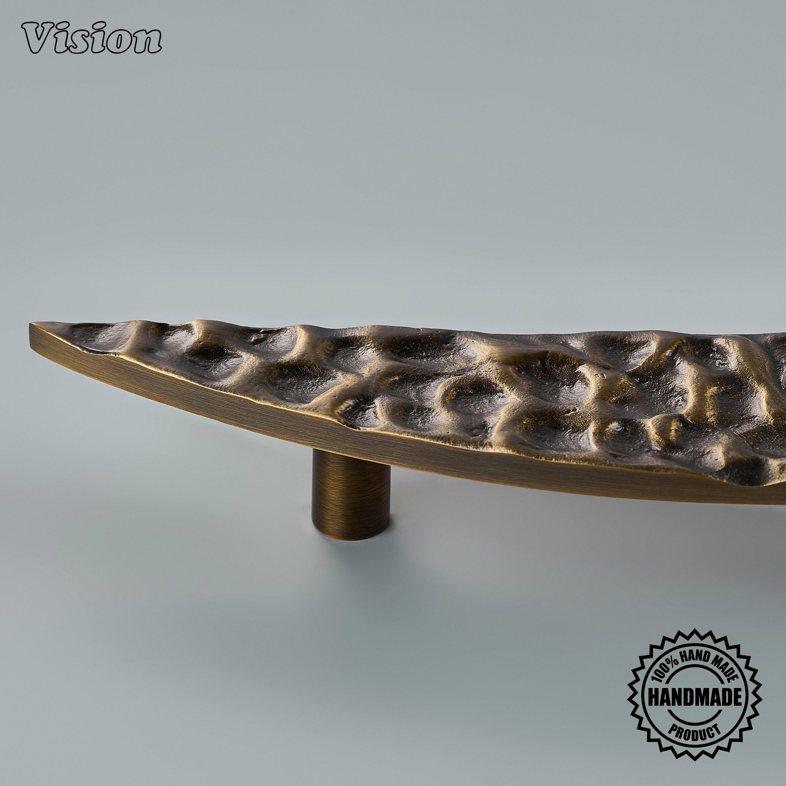 An elongated curved profile gives this Luna door handle in Antique Bronze a sculptural presence, while its textured surface and tapered ends suit a statement interior door.