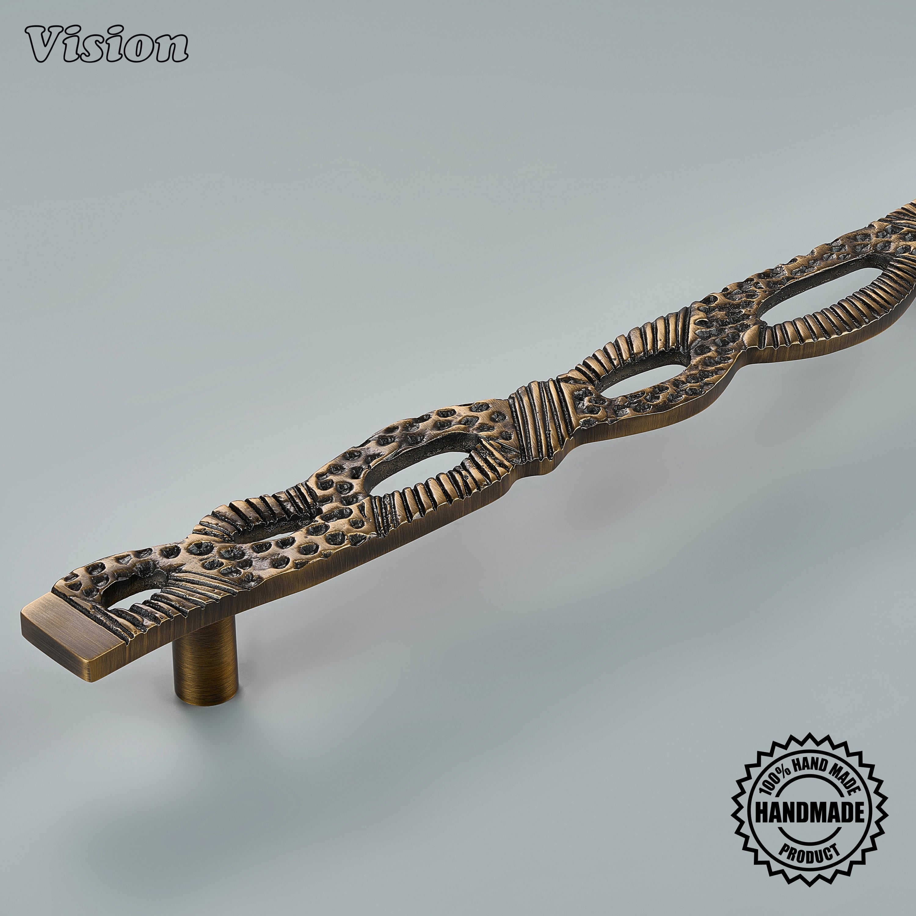 Sculpted antique bronze door handle with heavy macrame-inspired relief on panel-ready refrigerators