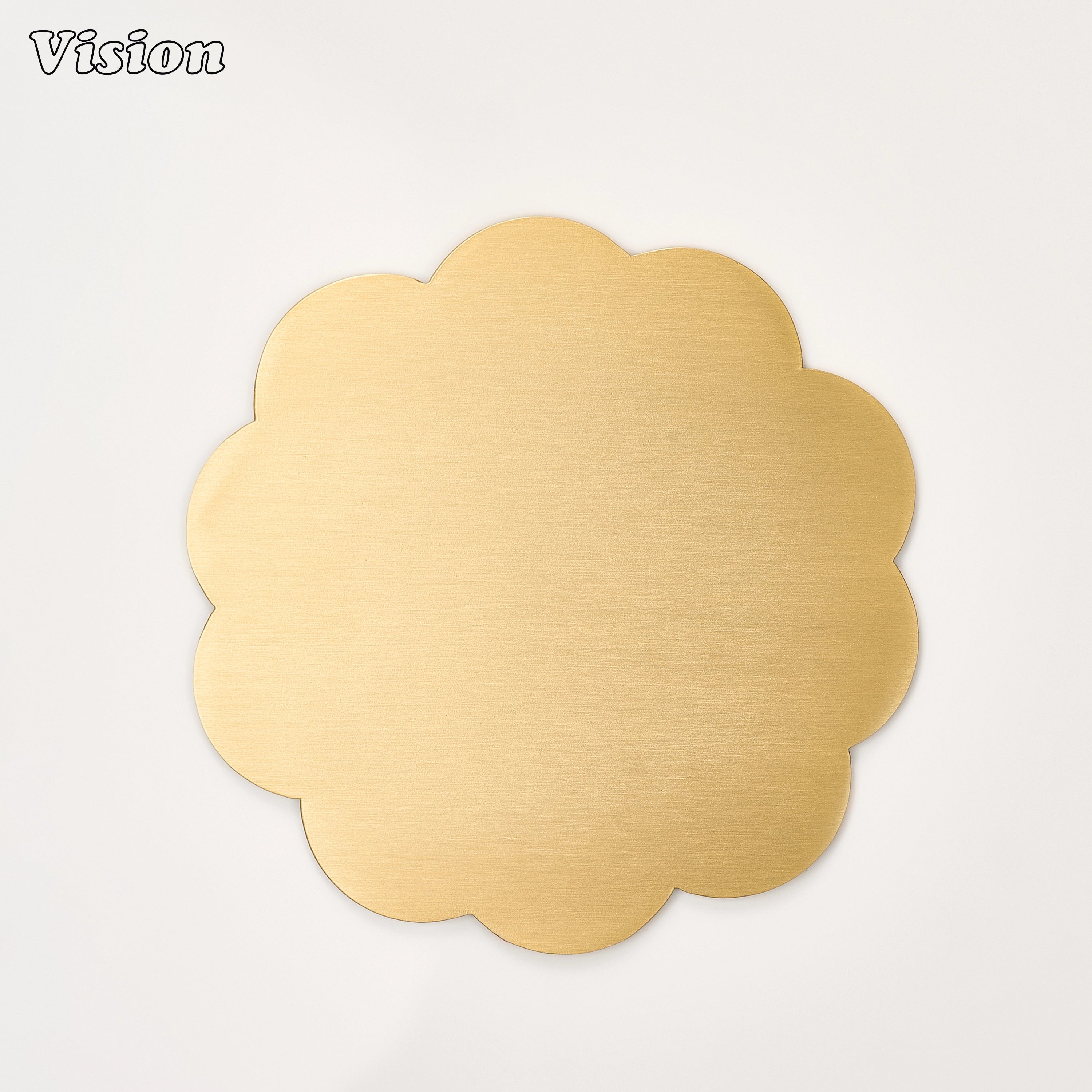 Gold solid brass scalloped coaster with an organic flower-inspired edge on a luxury dining table