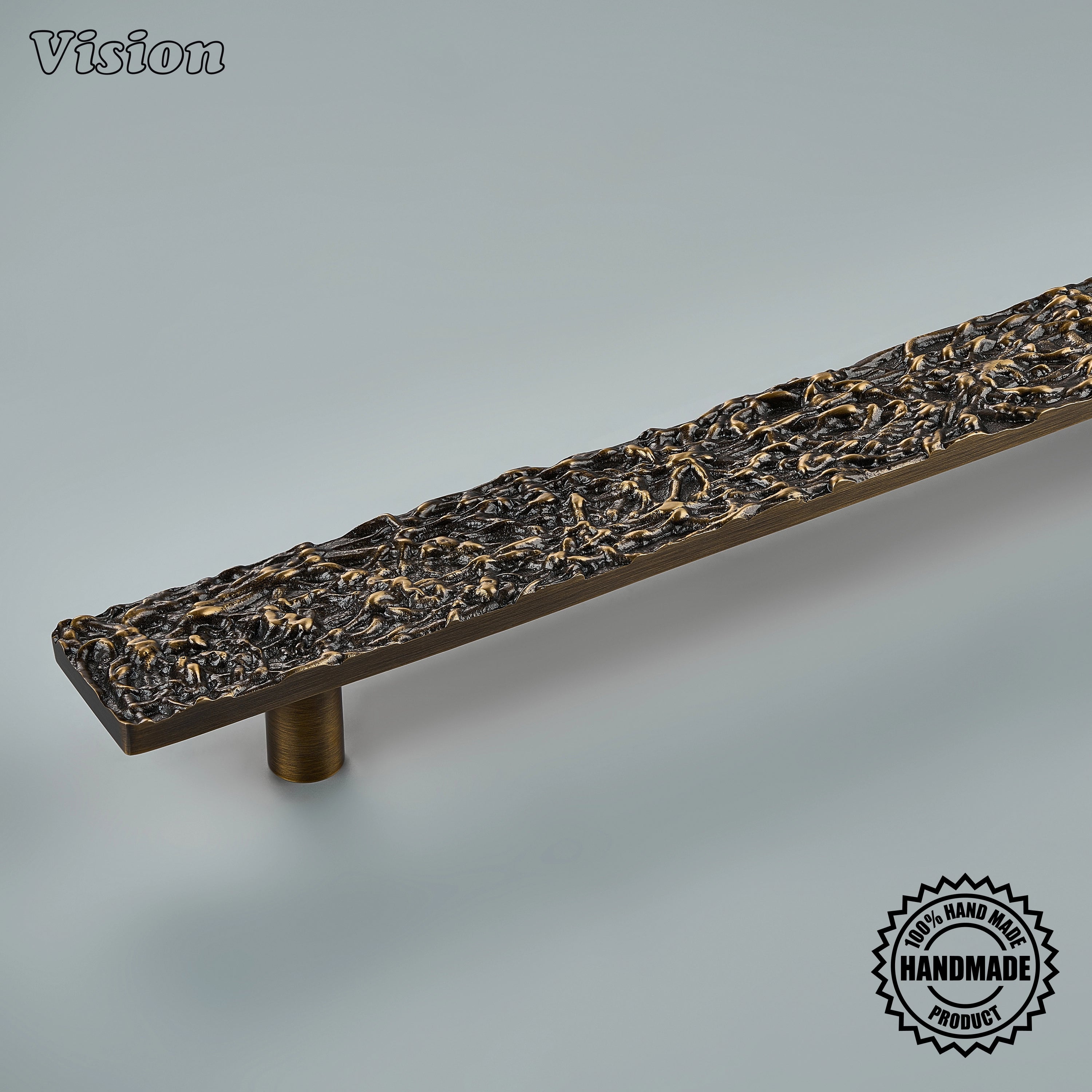Sculpted antique bronze door handle with organic branch-like relief on panel-ready refrigerators