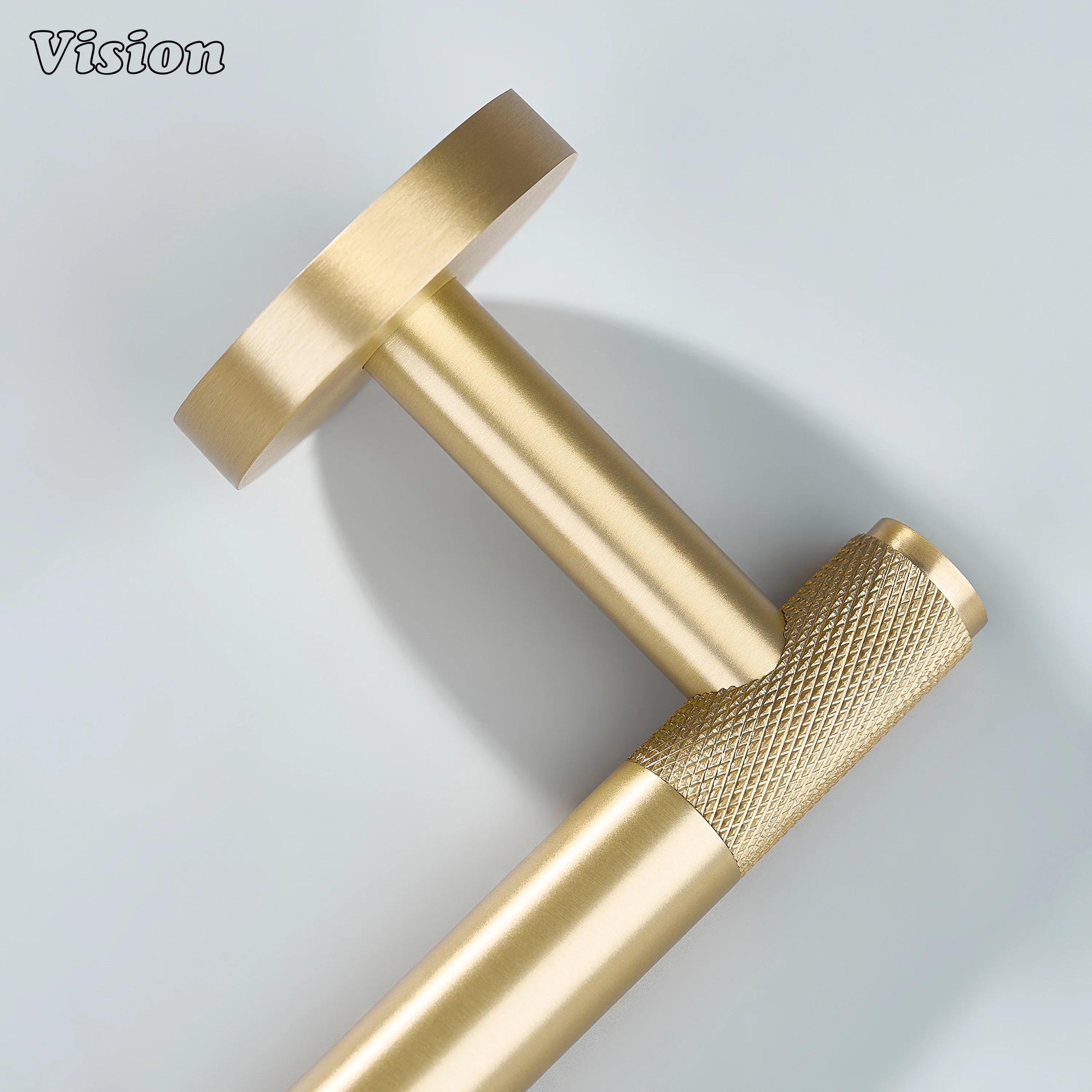 Minimal gold brass towel holder with knurled bar and round wall base for modern bathrooms