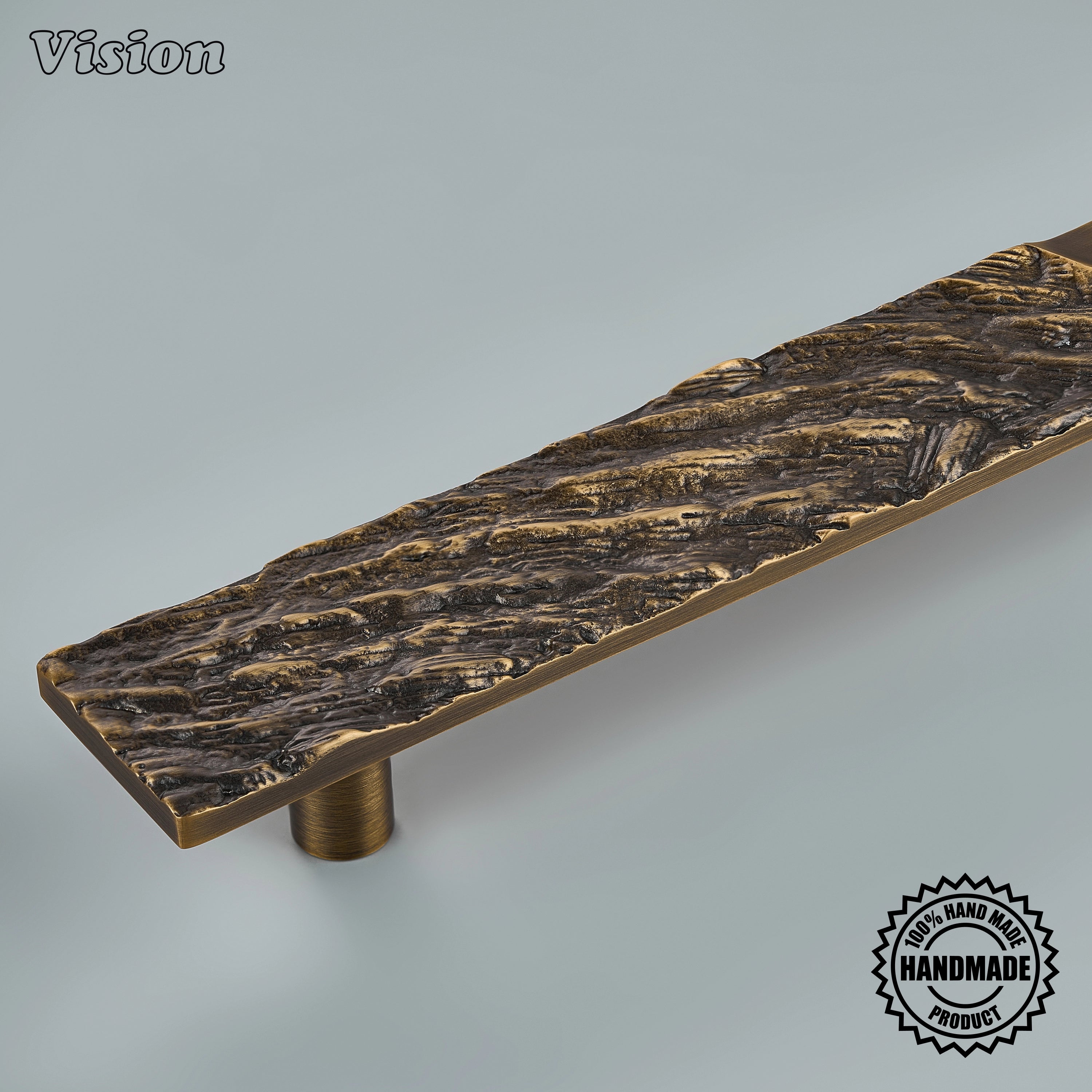Sculpted antique bronze door handle with heavy wood-inspired ridges on panel-ready refrigerators