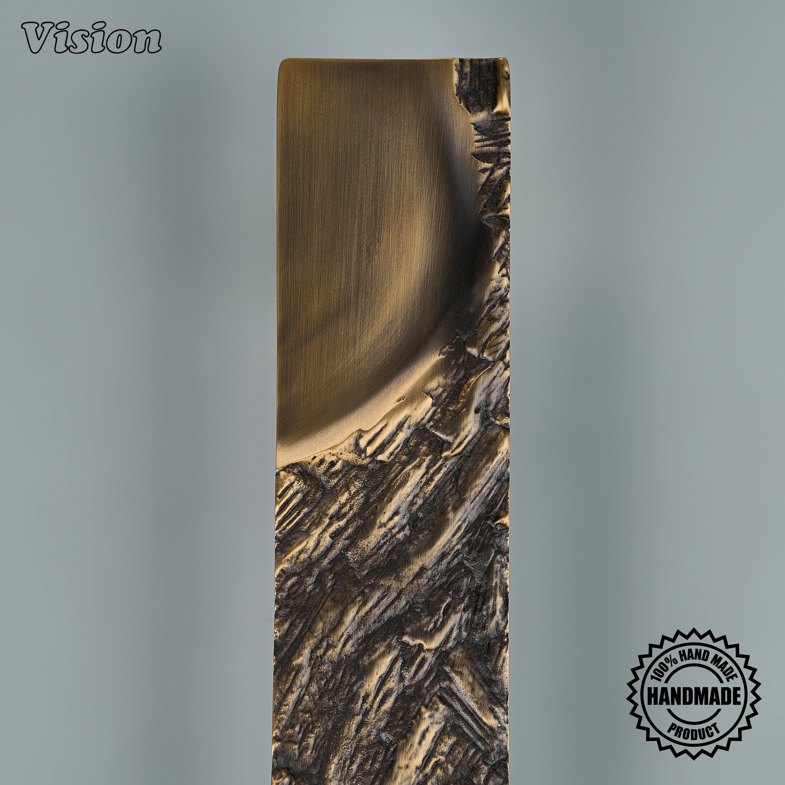 Antique bronze appliance pull featuring a handcrafted tactile woodgrain surface for luxury armoires