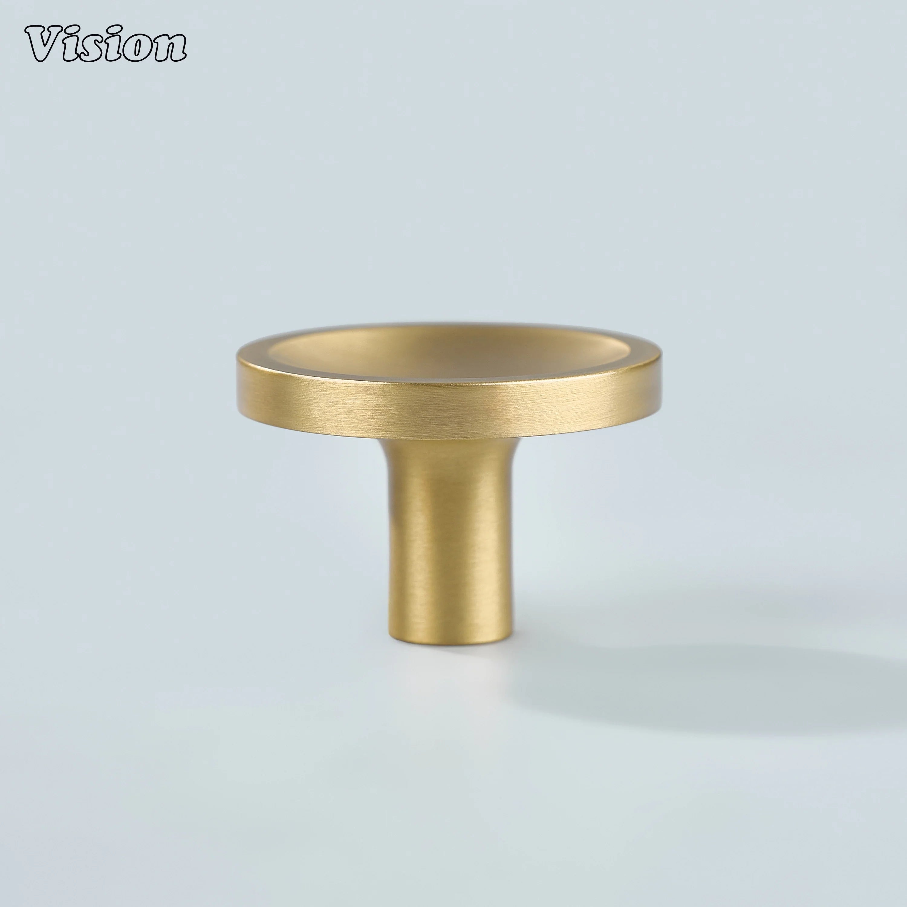 Gold plain round cabinet knob featuring dished surface detail for modern wardrobe doors