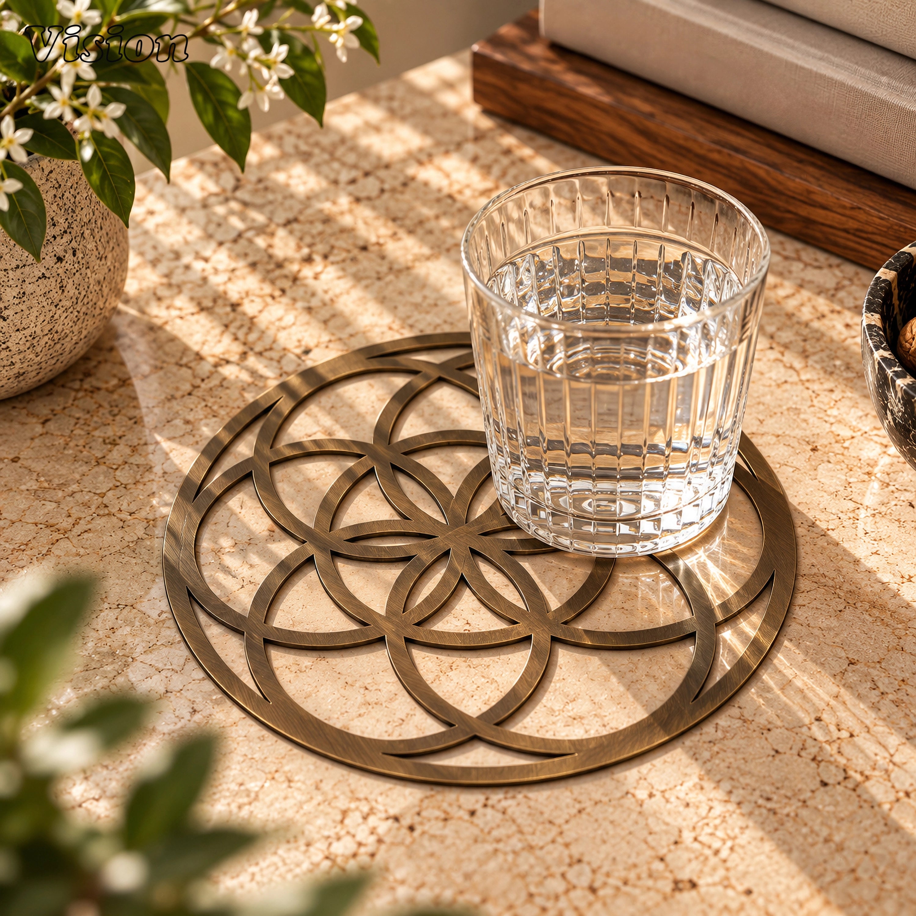 Round antique bronze tabletop coaster with Seed of Life geometric cutouts on a modern dining table