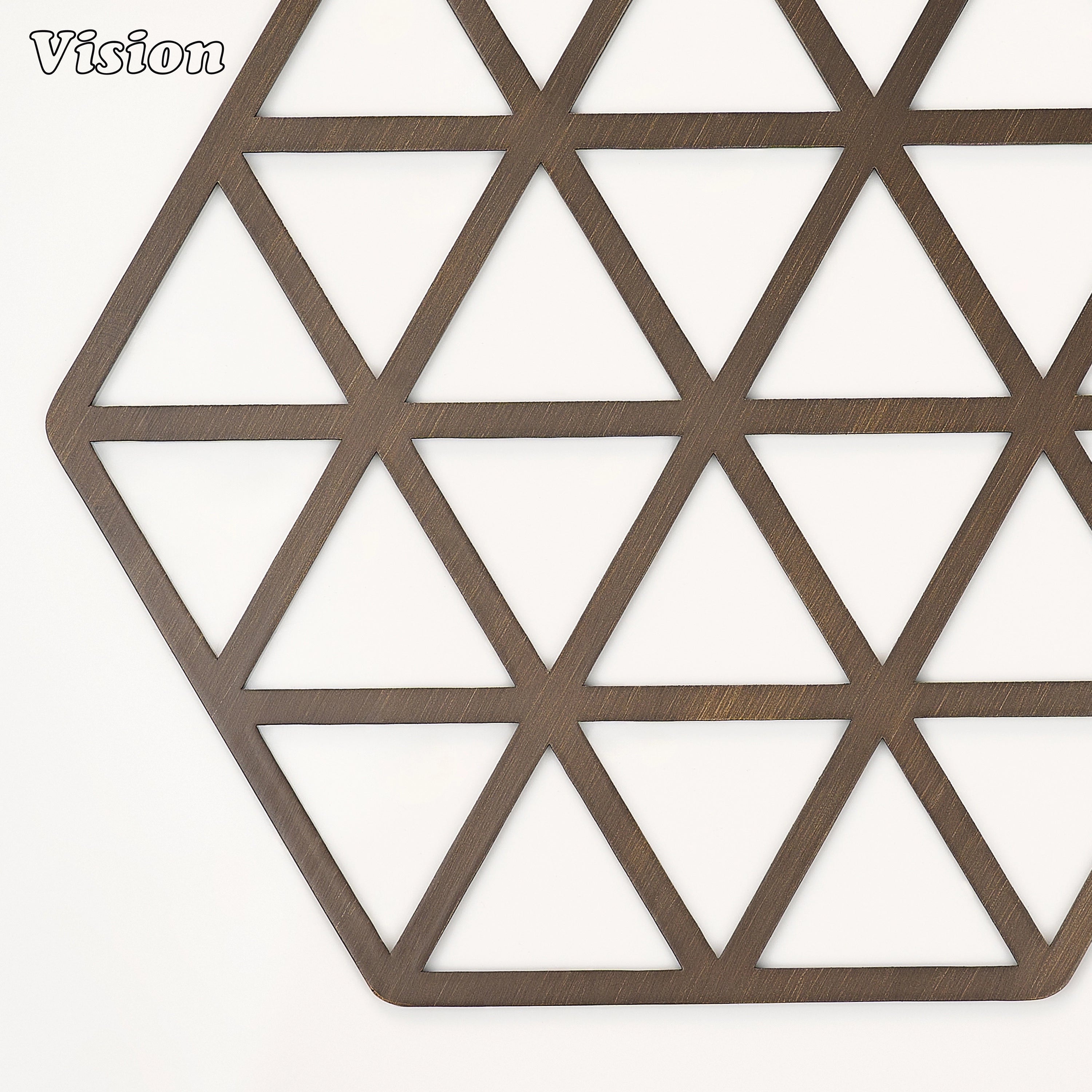 Sleek antique bronze solid brass drink coaster with geometric cutouts on a contemporary office desk