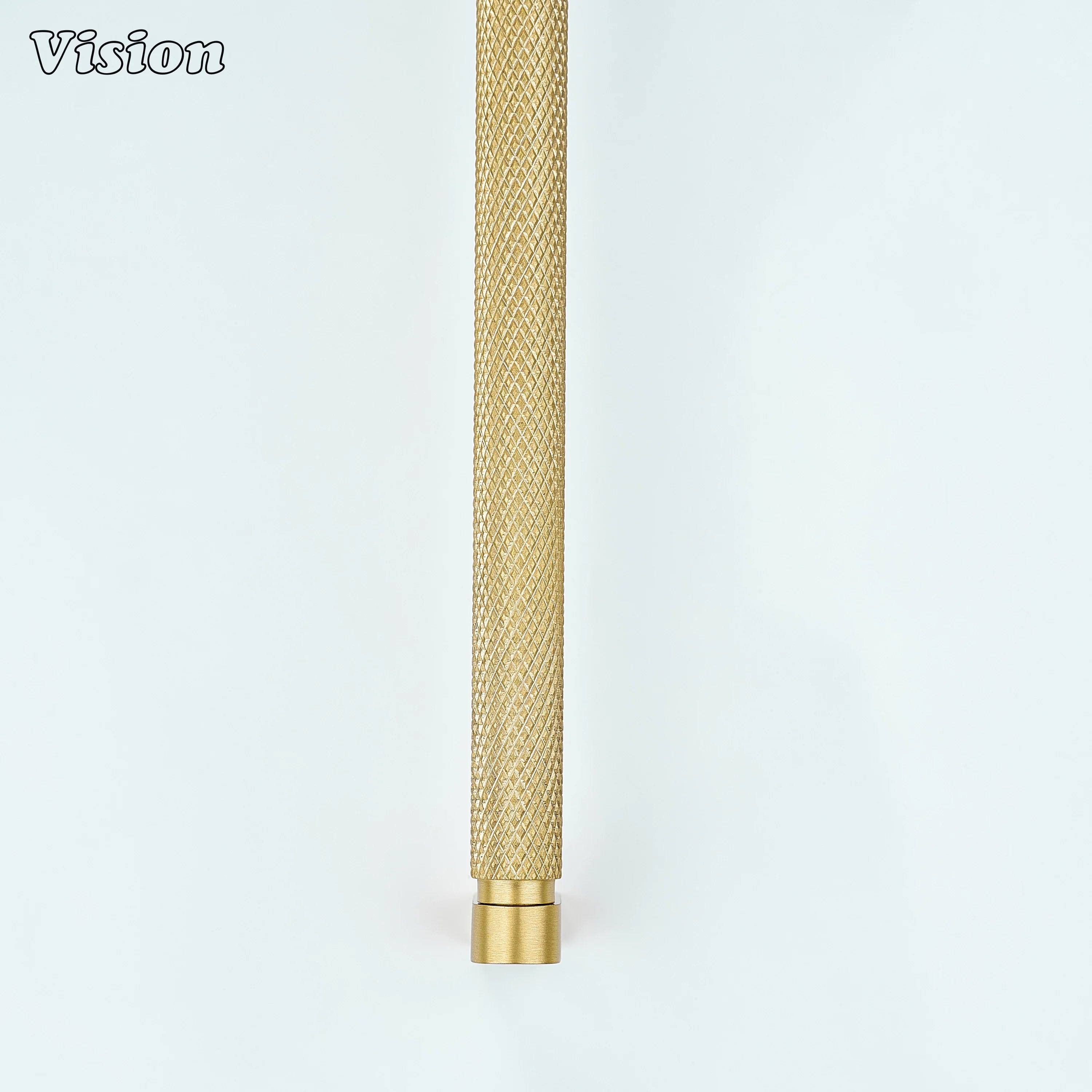 Gold ripple knurled cabinet handle mounted on furniture drawers.