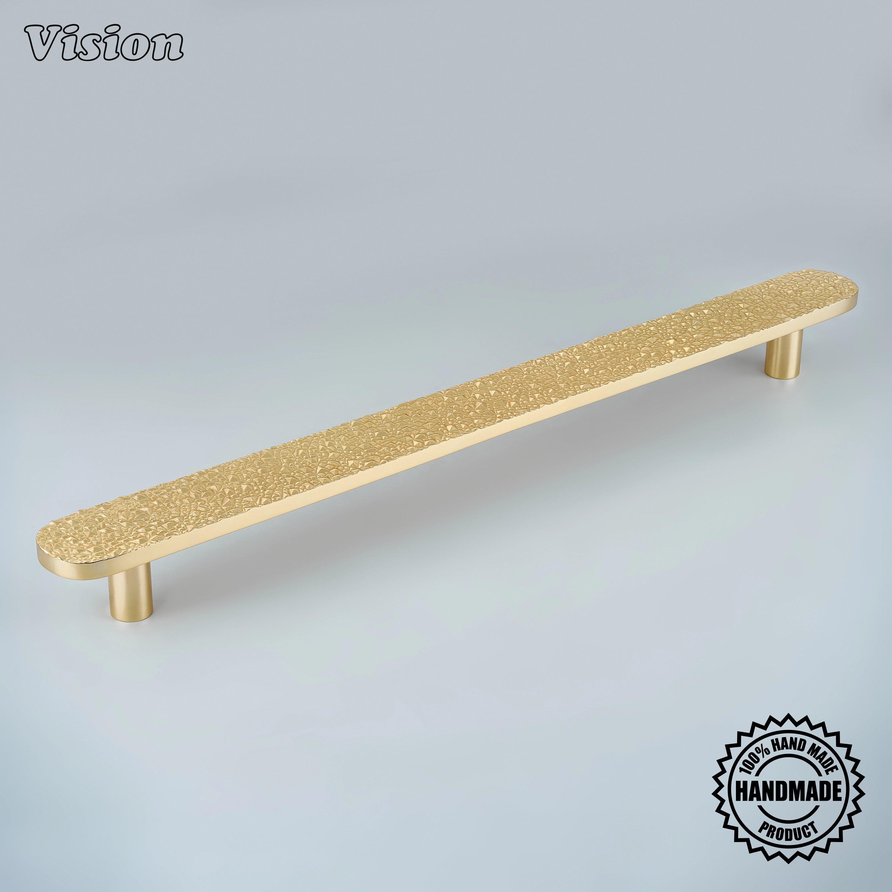 Polished Brass handcrafted appliance pull with chiseled rock texture and cylinder legs on pantry doors