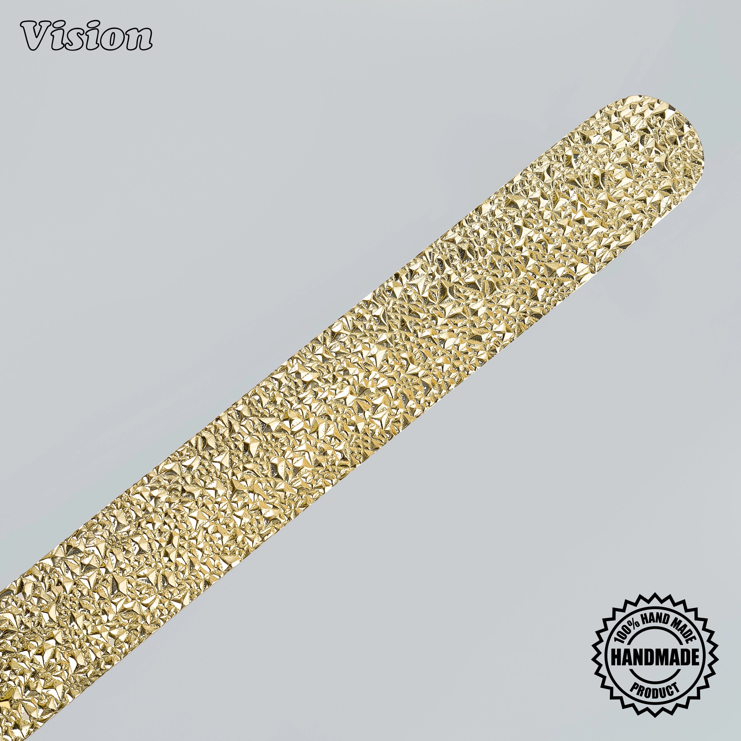 Handcrafted polished brass appliance pull with organic stone relief on oversized architectural doors