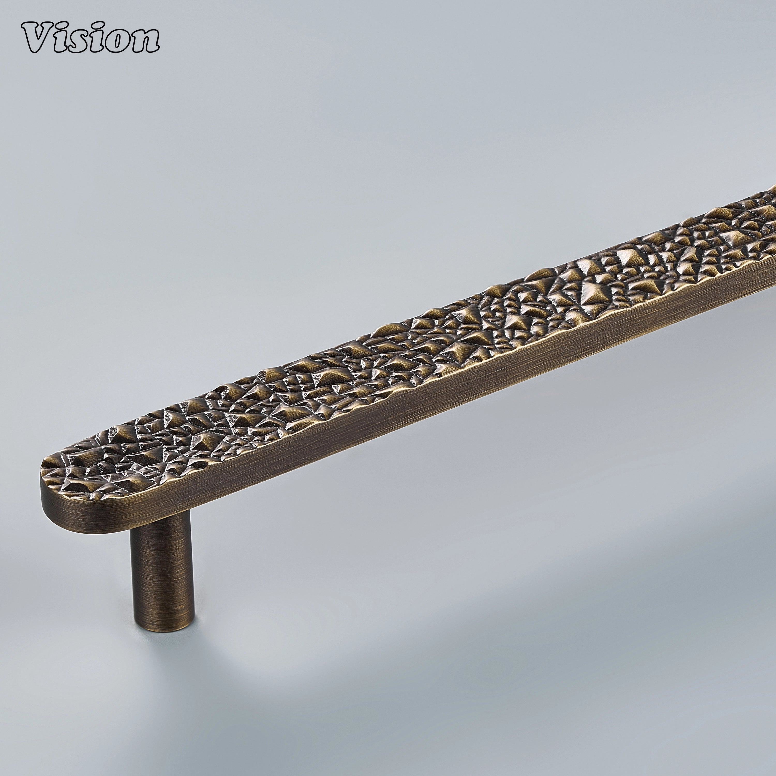 Antique Bronze handcrafted cabinet pull with chiseled rock texture on modern kitchen cabinets