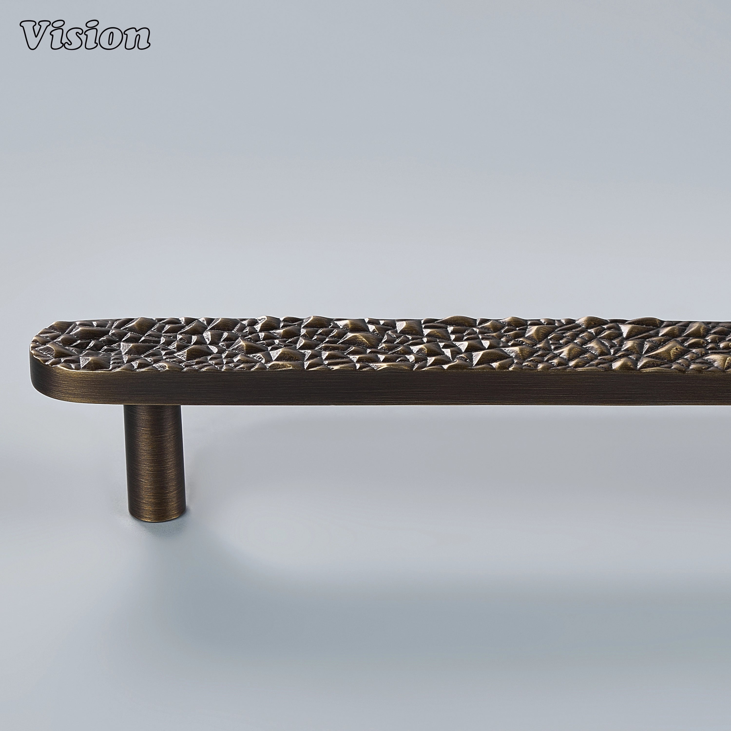 Antique bronze artisanal cabinet handle with tactile rocky surface and solid posts for joinery
