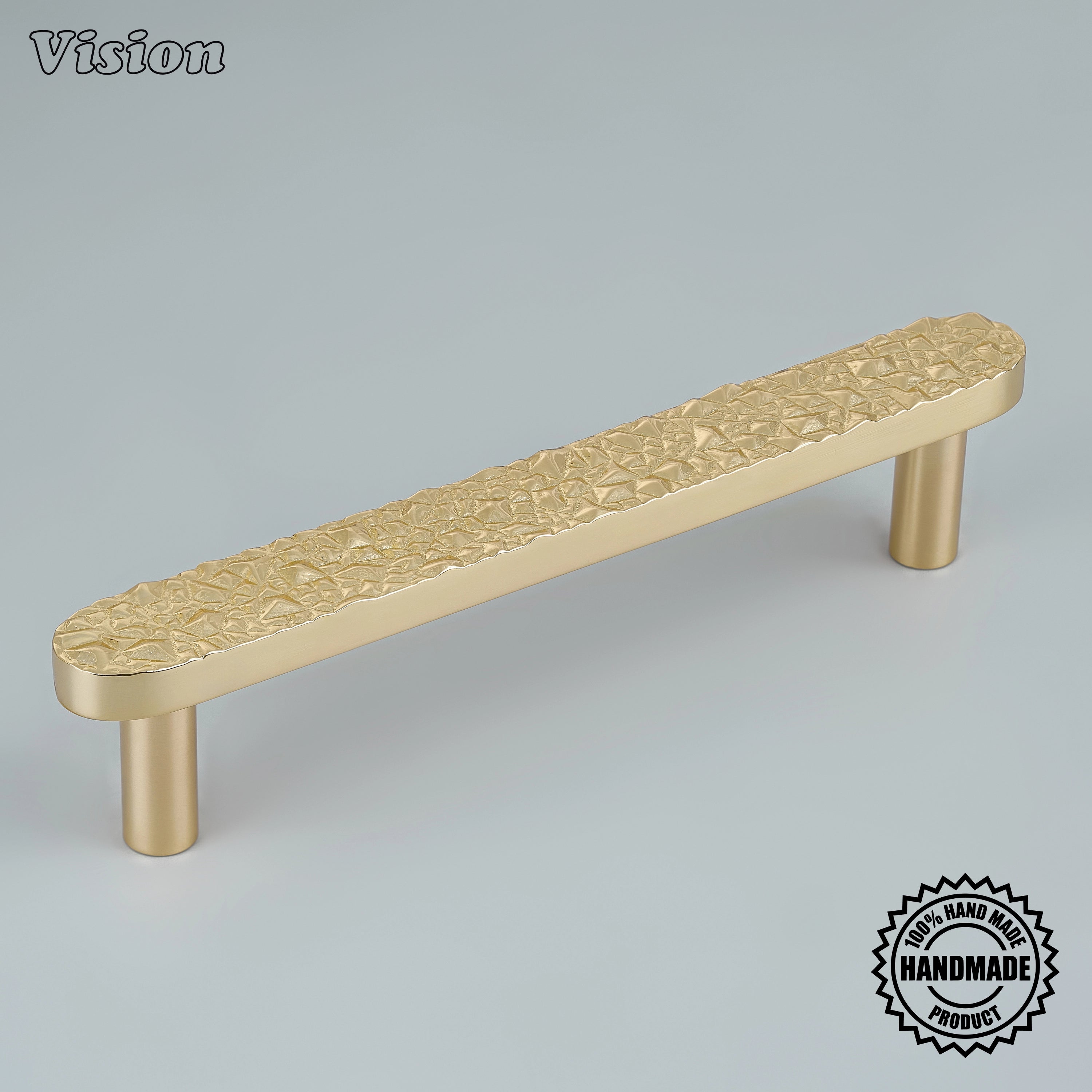 Sculpted polished brass cabinet handle with crushed stone relief mounted on custom statement drawers