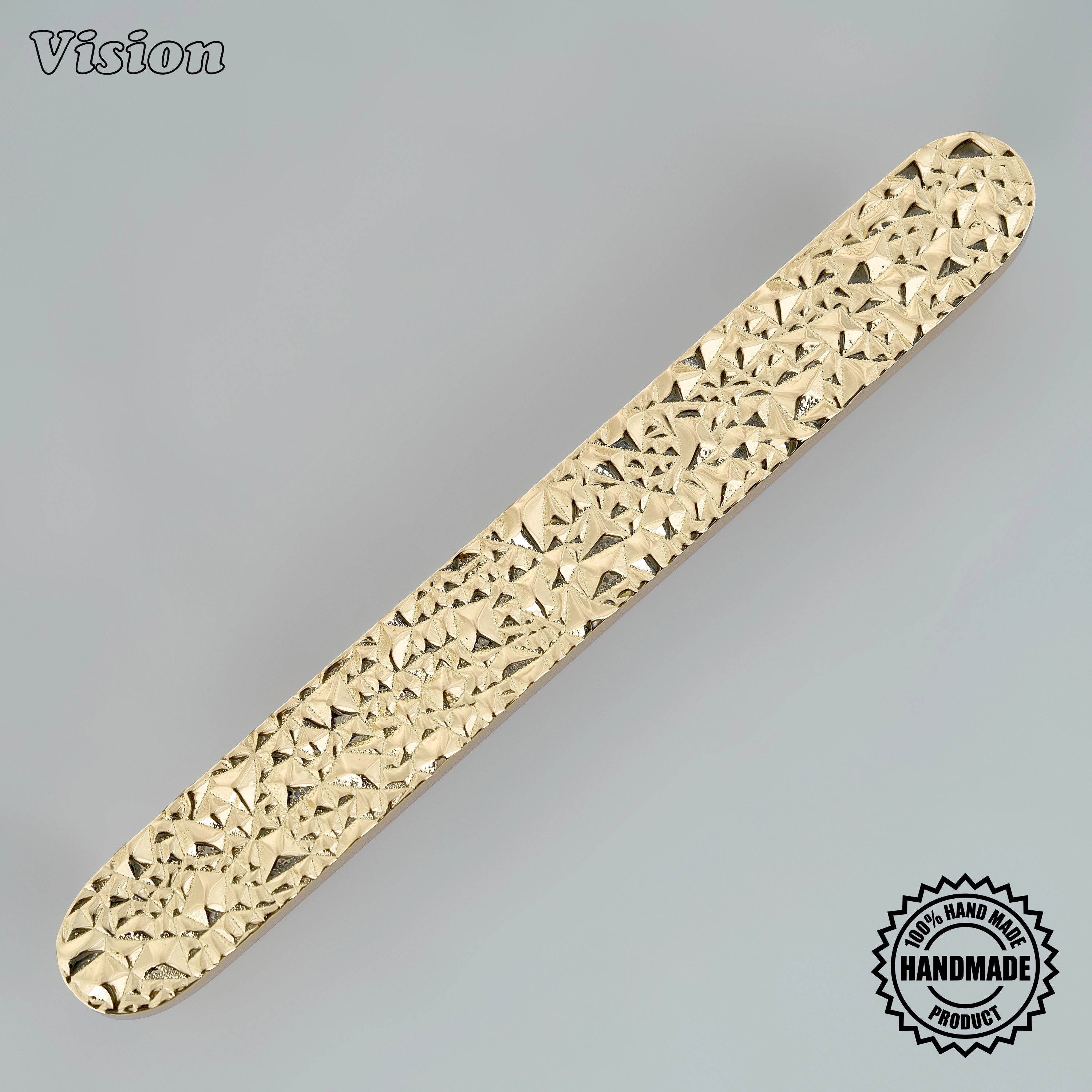 Polished brass artisanal cabinet handle with tactile rocky surface and solid posts for custom joinery