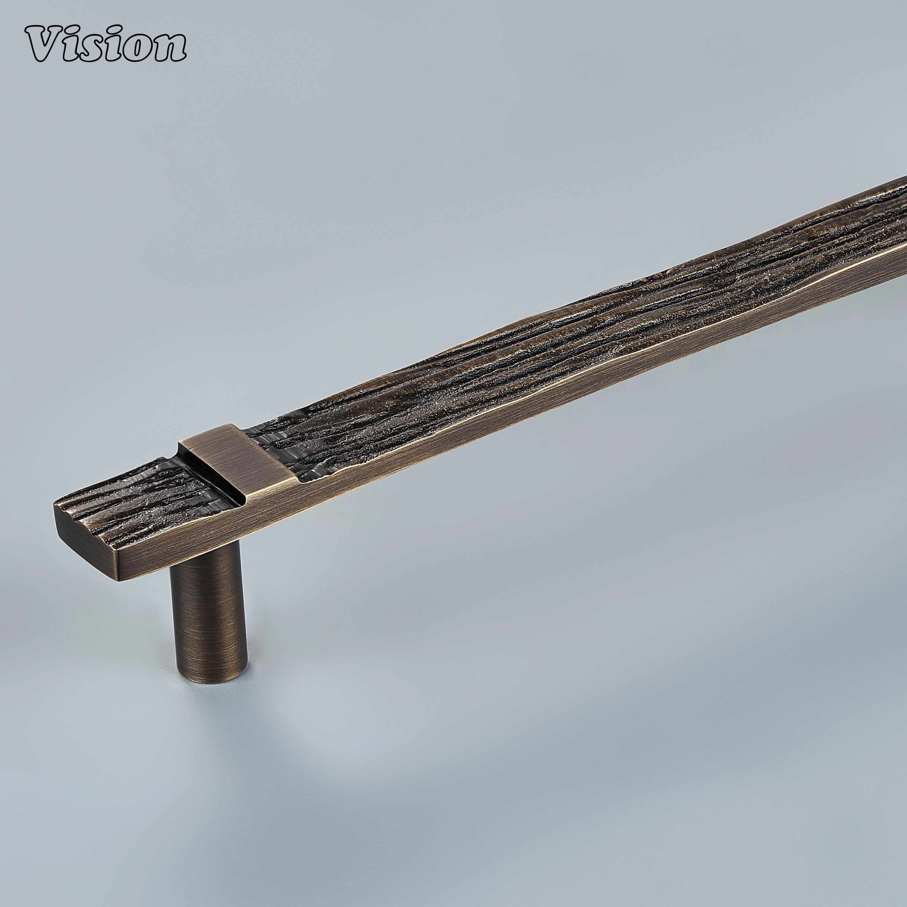 Antique Bronze handcrafted cabinet pull with deeply carved parallel texture on kitchen cabinets