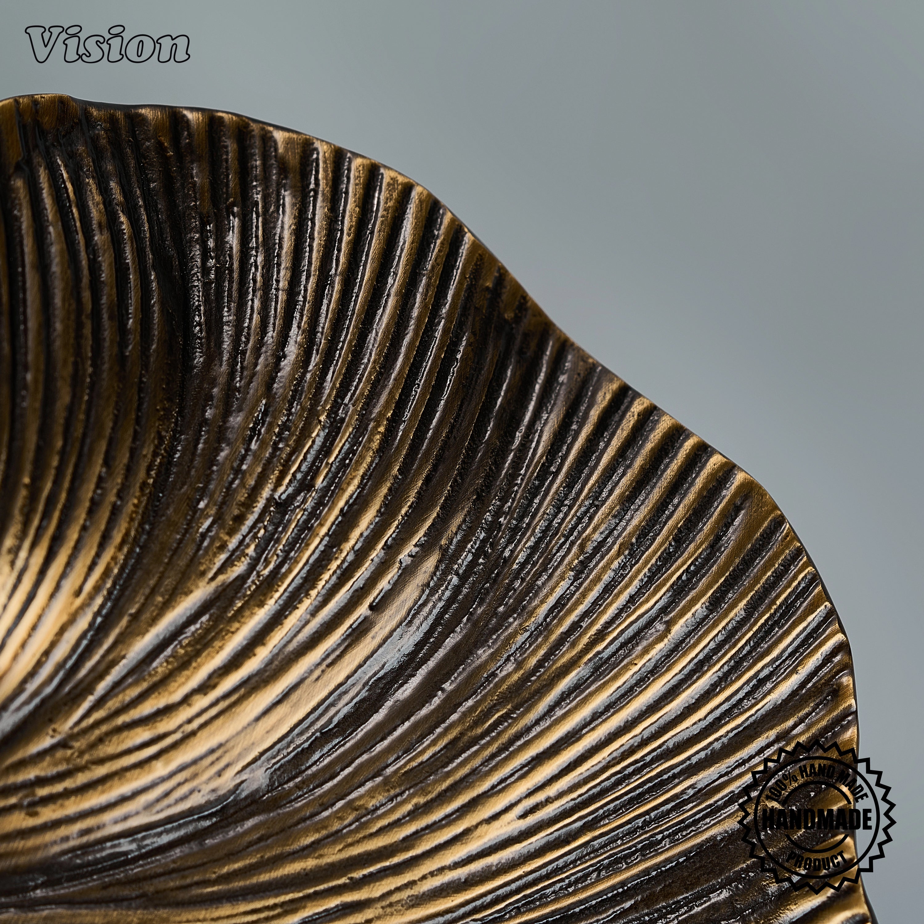 Textured antique bronze sculpted door pull with radiating lines on custom timber doors