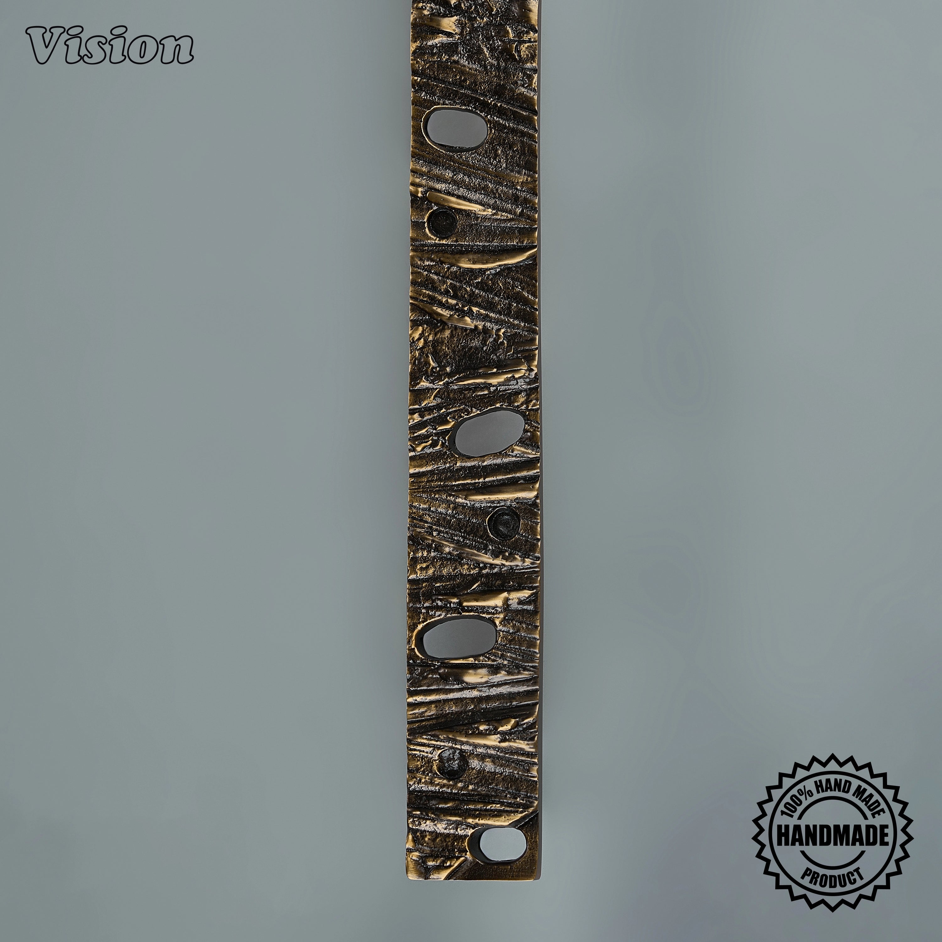 Sculpted antique bronze appliance pull handle with rugged bar profile on integrated freezers