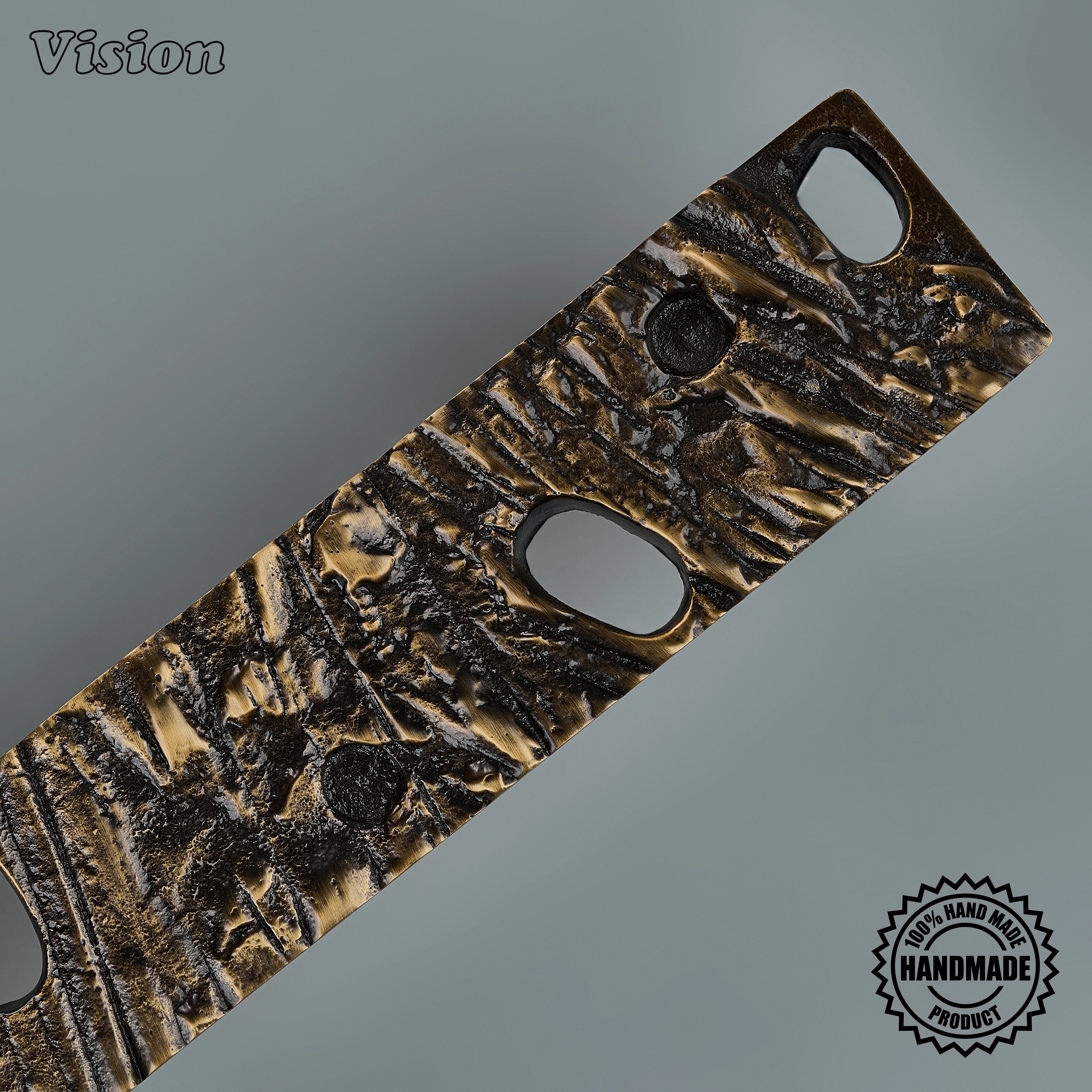 Antique bronze artisanal door handle featuring tactile relief on interior double doors