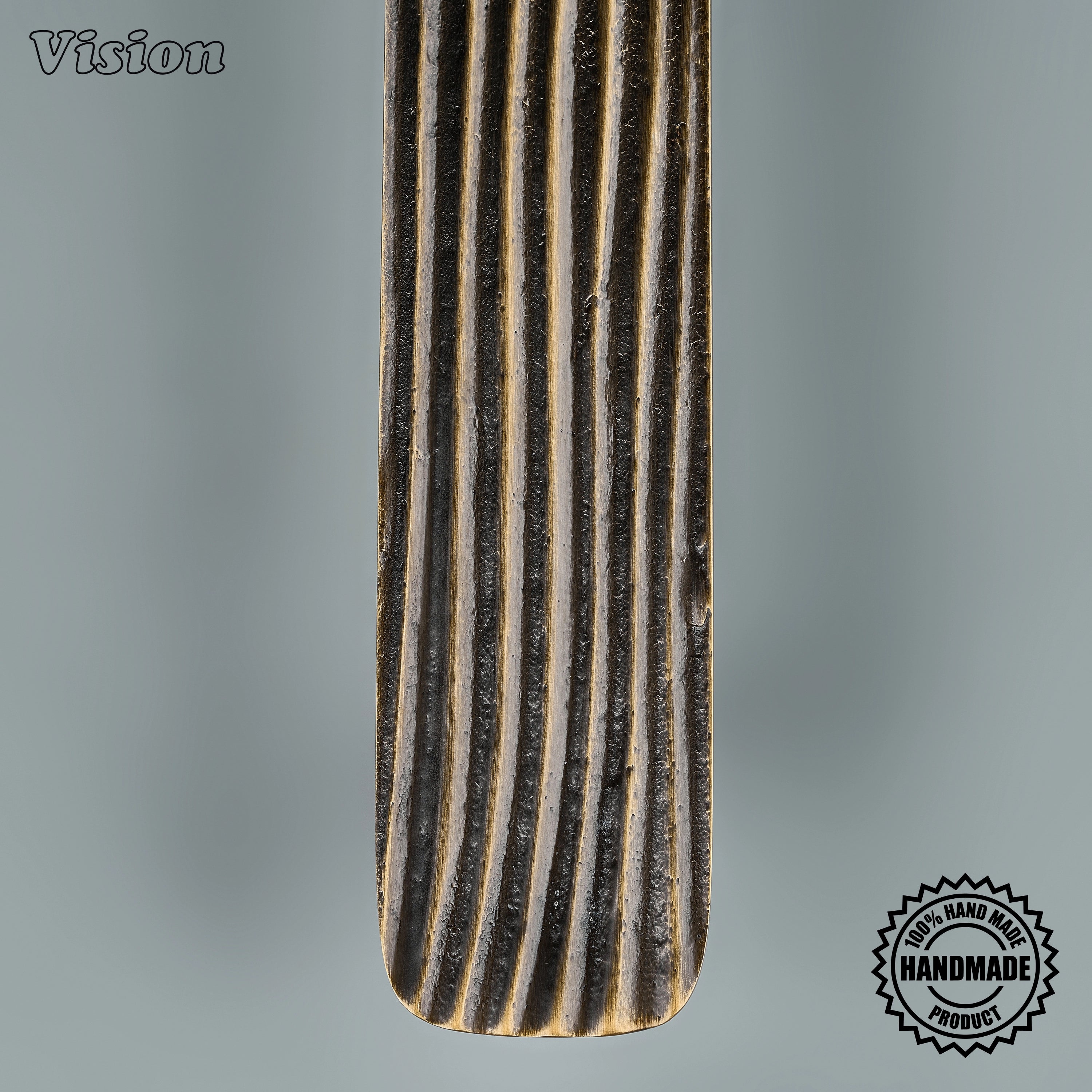 Handcrafted antique bronze appliance pull with strata relief on oversized entryway doors