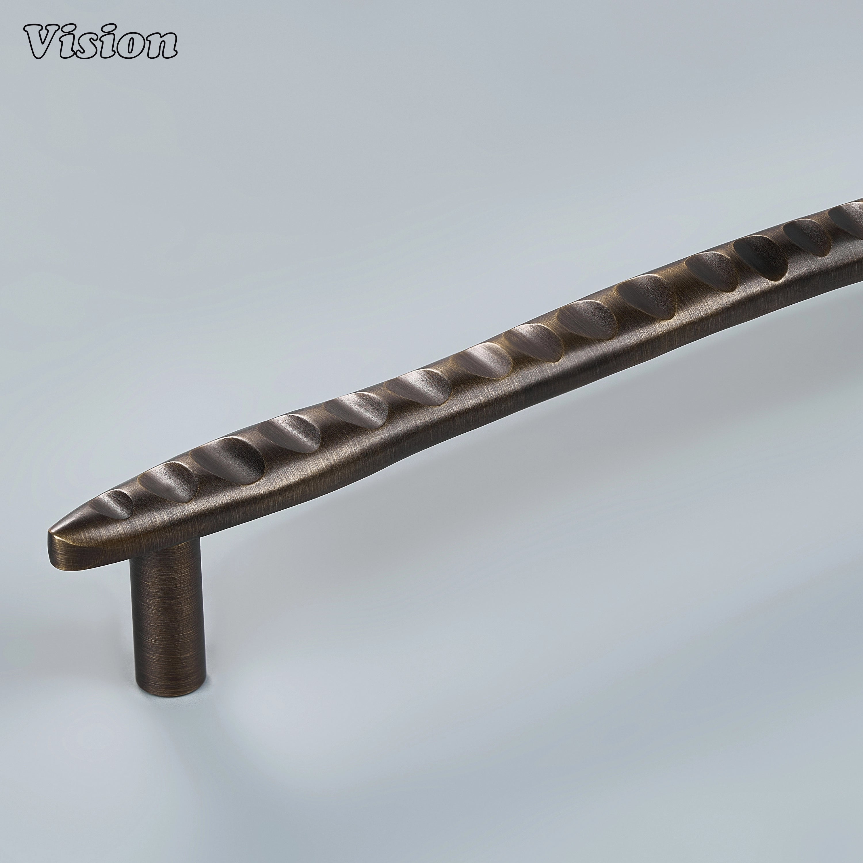 Antique Bronze handcrafted cabinet pull with flowing wave texture on kitchen cabinets