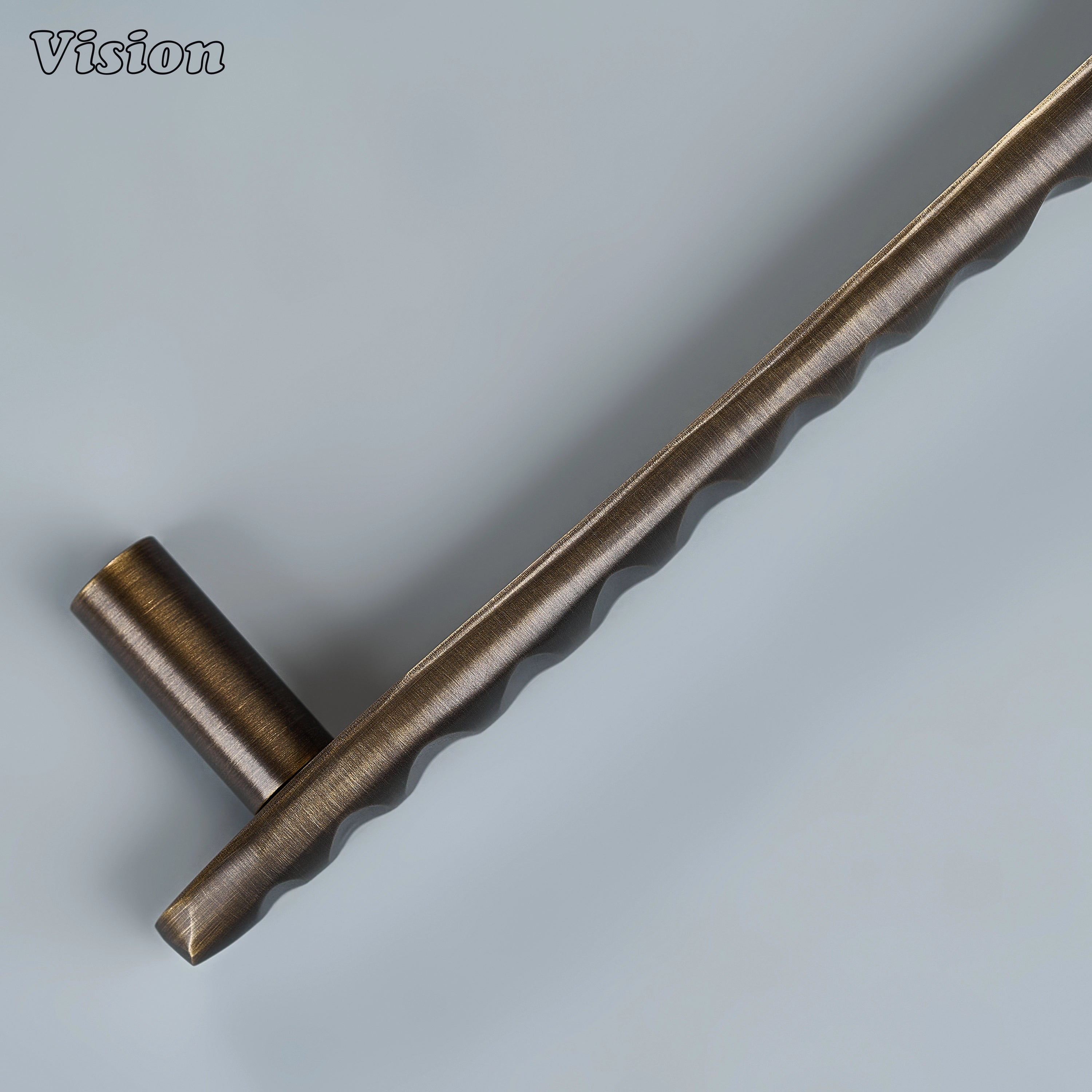 Antique bronze artisanal cabinet handle with tactile flowing surface for custom joinery