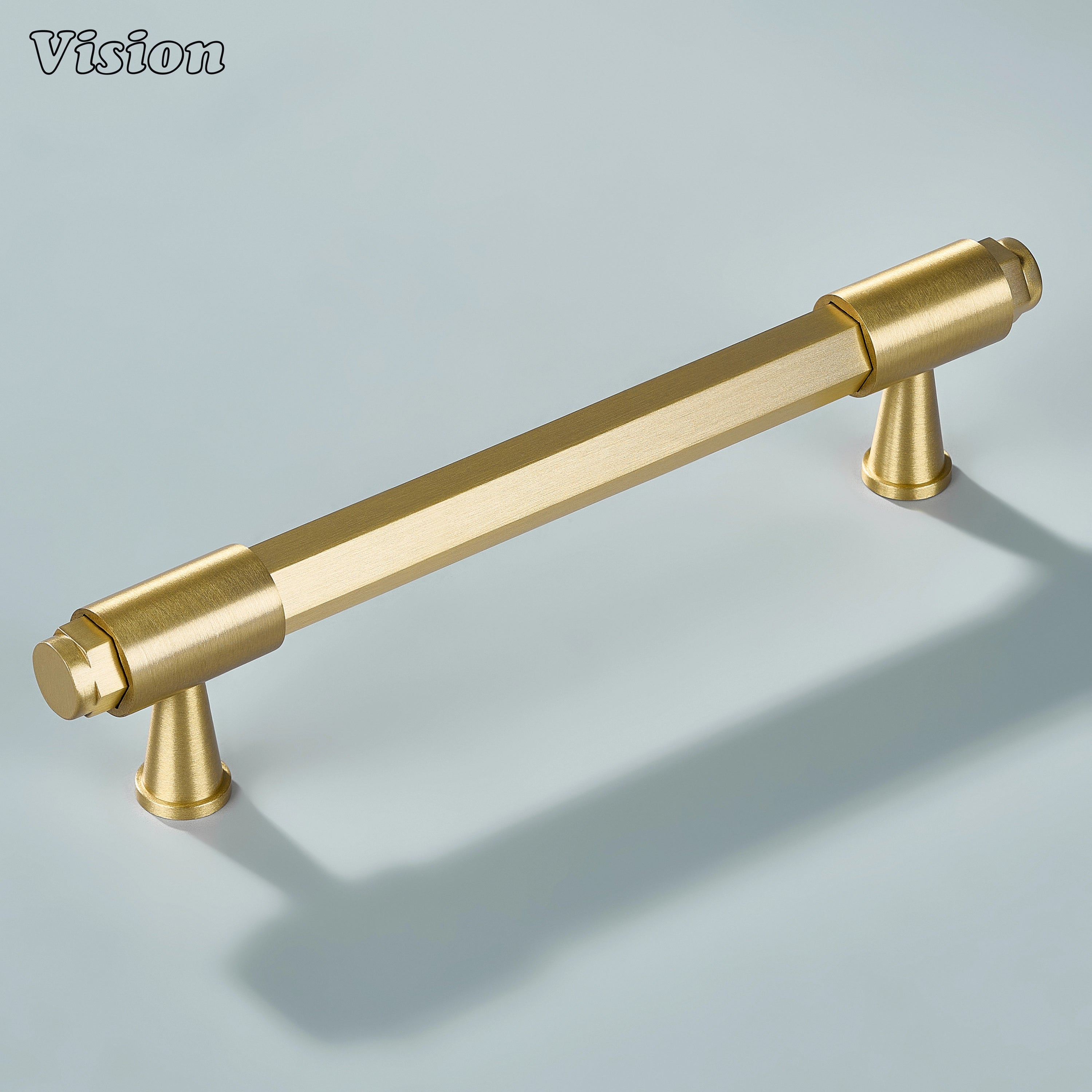 Gold brass cabinet handle with geometric hexagonal design, circular ends and ring detailed legs for furniture drawers