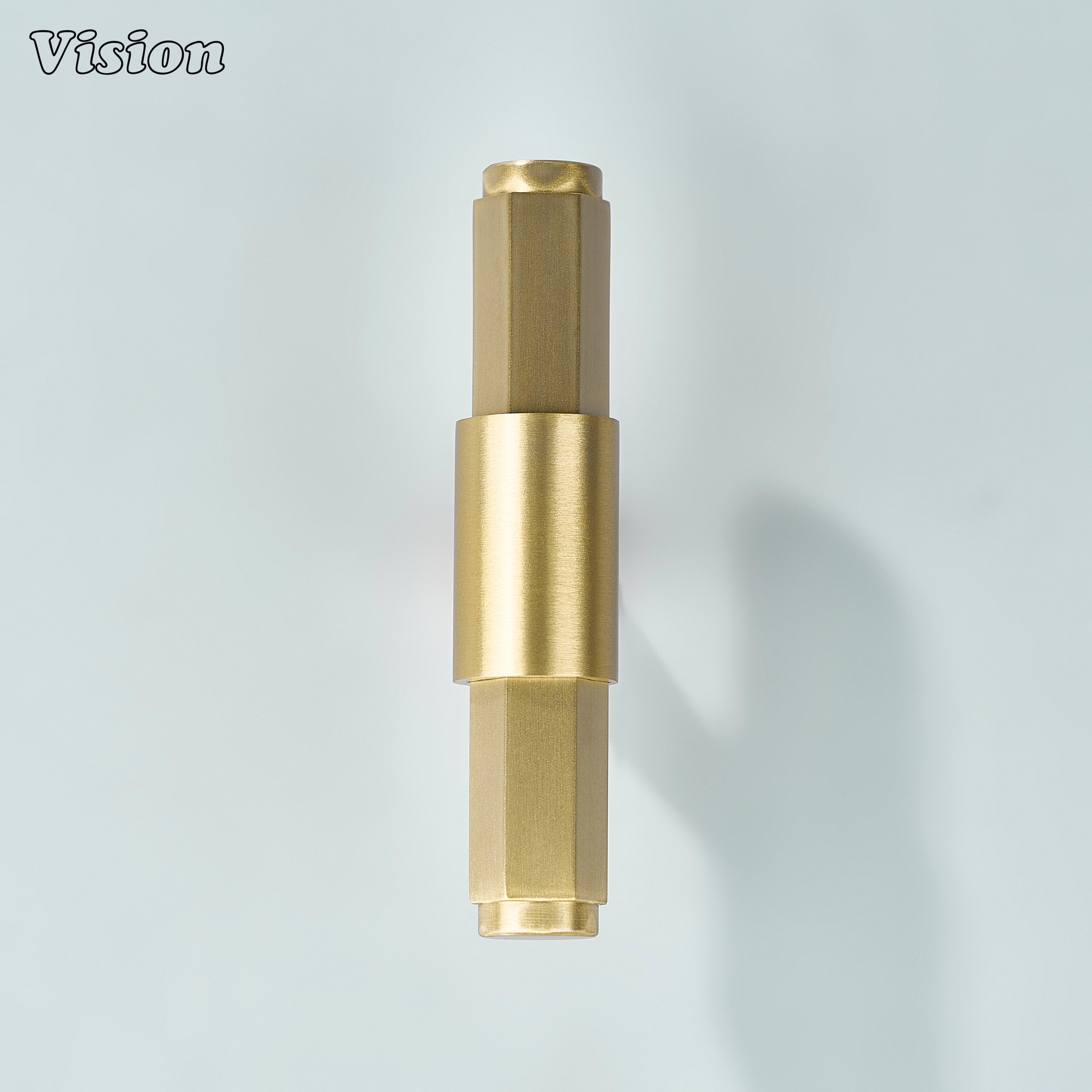 Gold T-knob with angular hexagonal profile and circular center detail for furniture cabinets