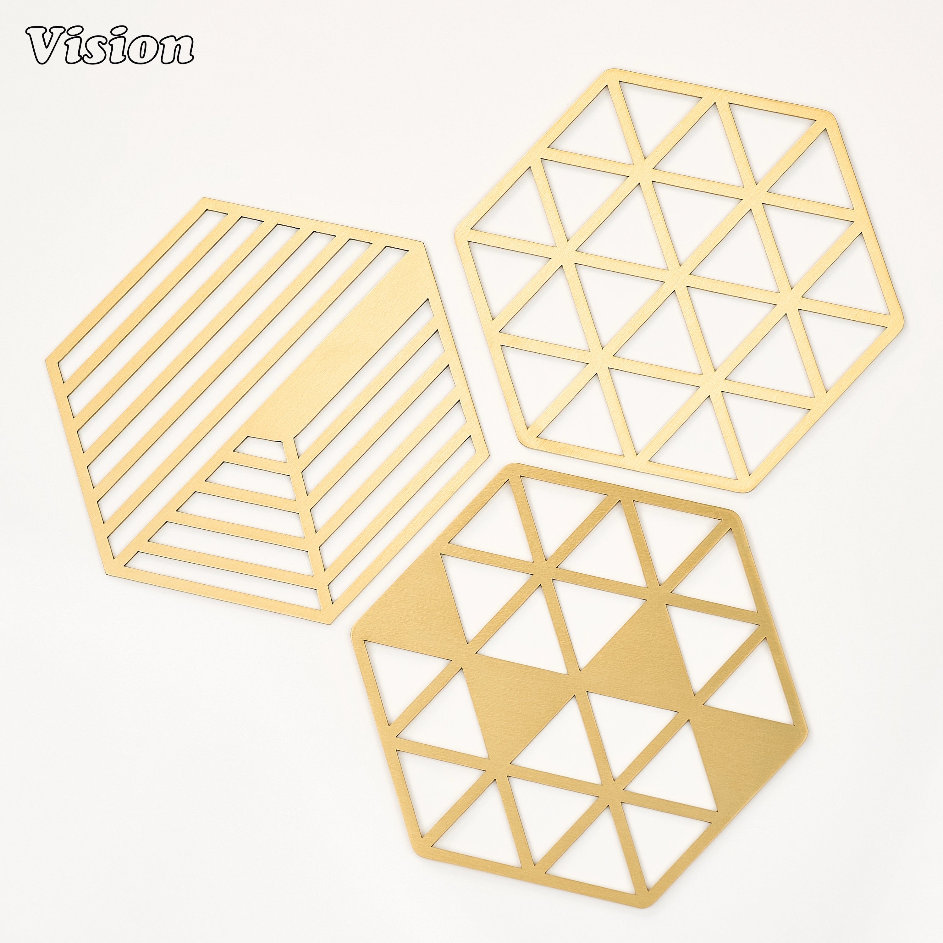 Premium gold geometric brass coaster with sharp directional cuts protecting a marble coffee table
